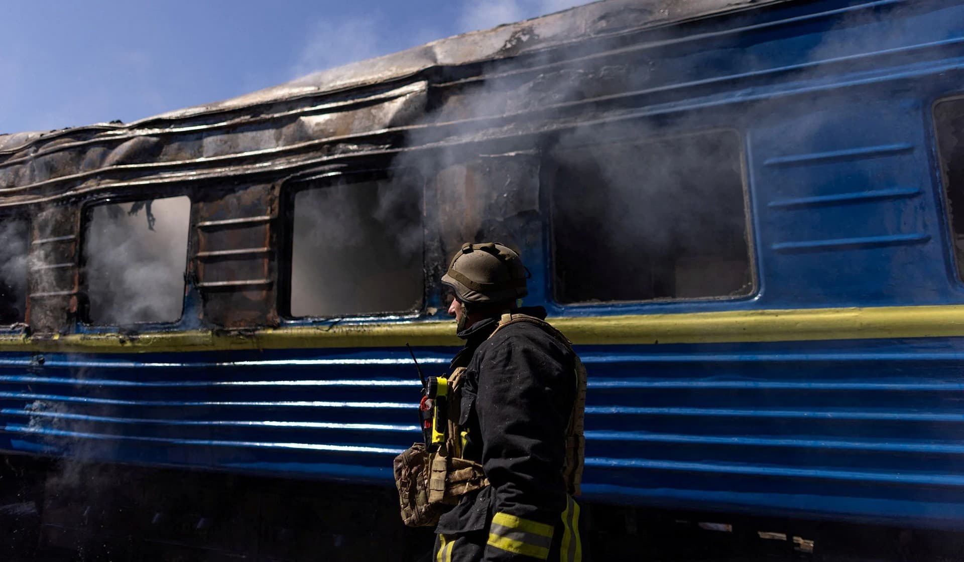A firefighter works at the site of a train station hit by a Russian military strike in Kherson