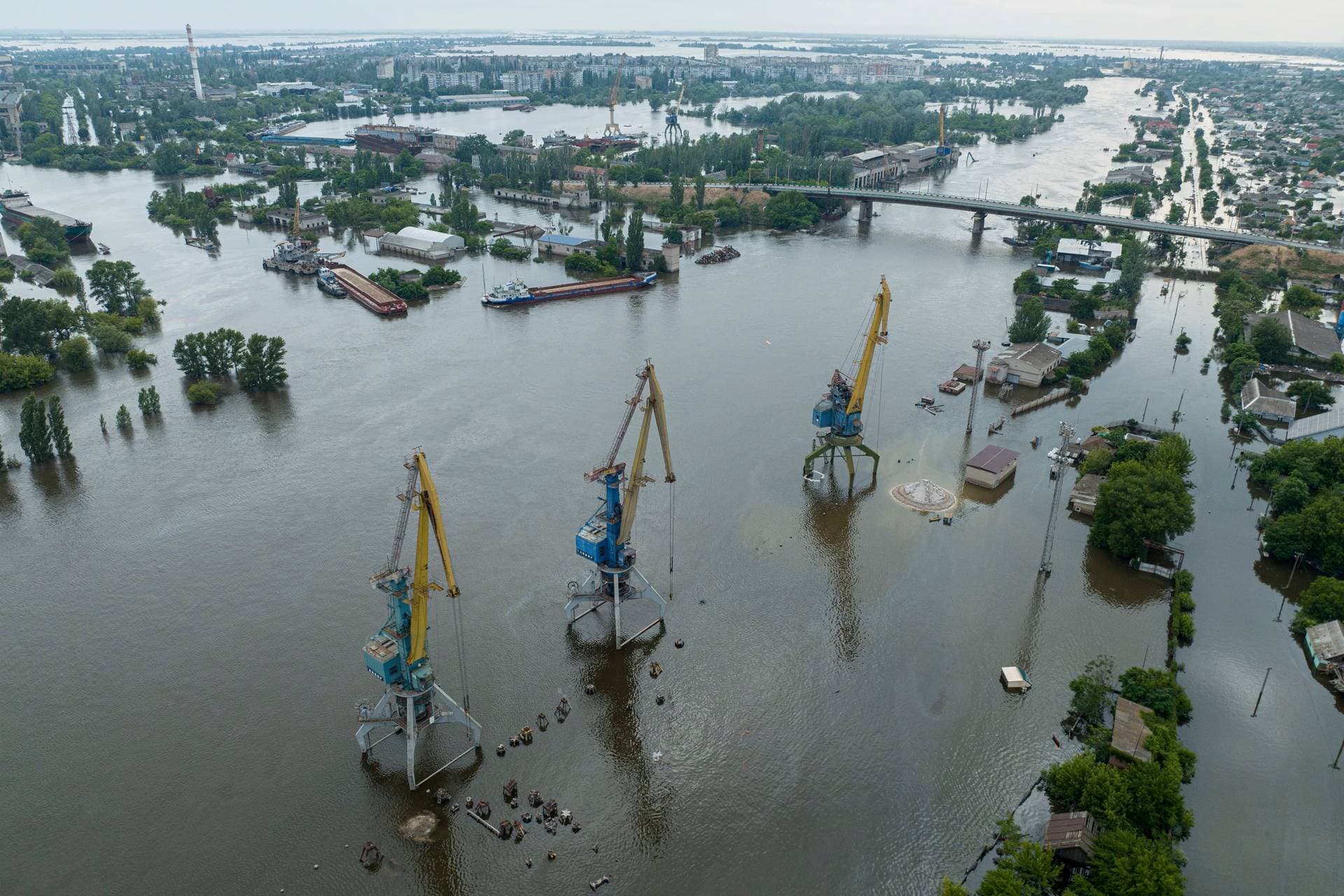 Streets and trade port are seen underwater and polluted by oil in the flooded Kherson