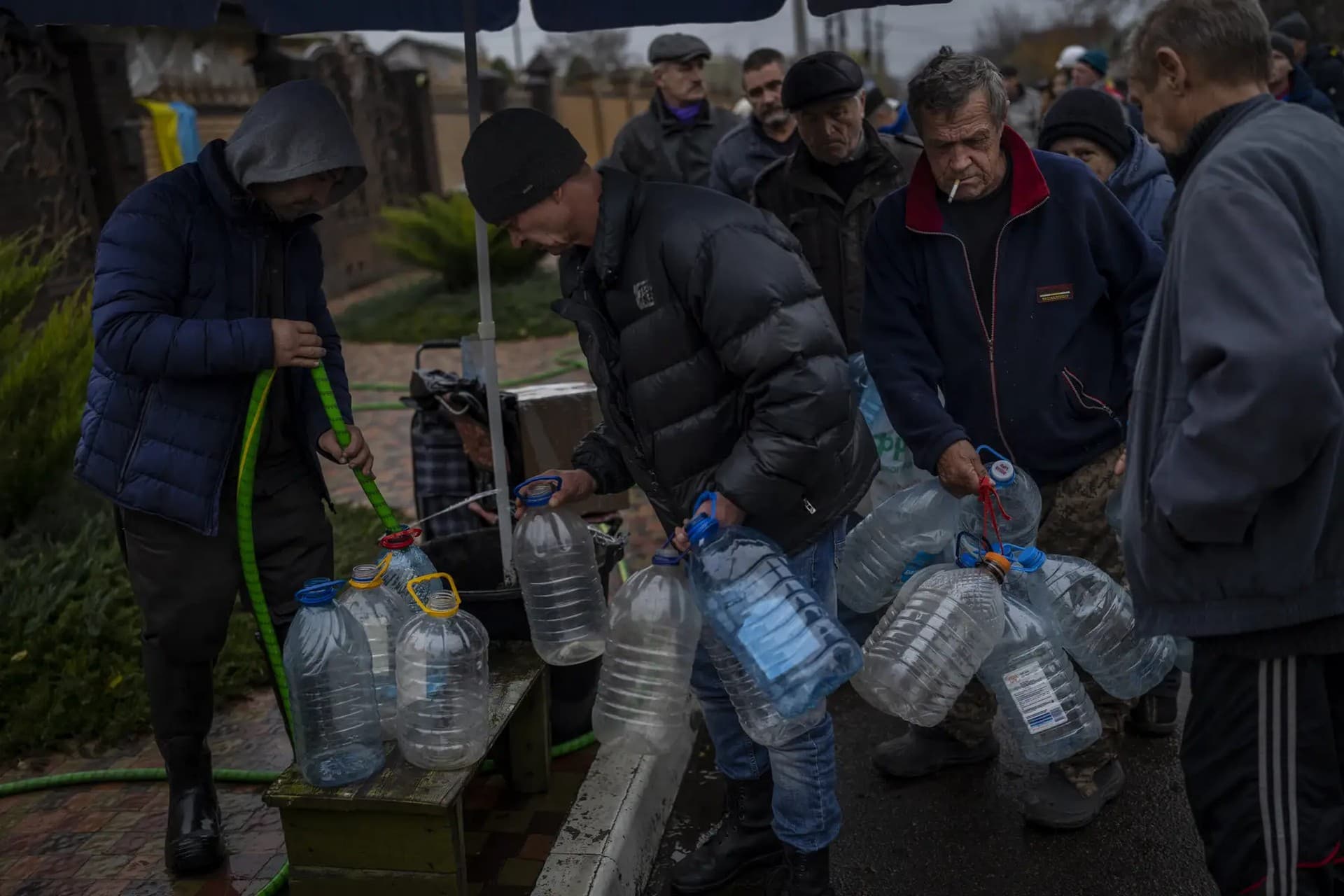 Residents fill containers with drinking water in Kherson