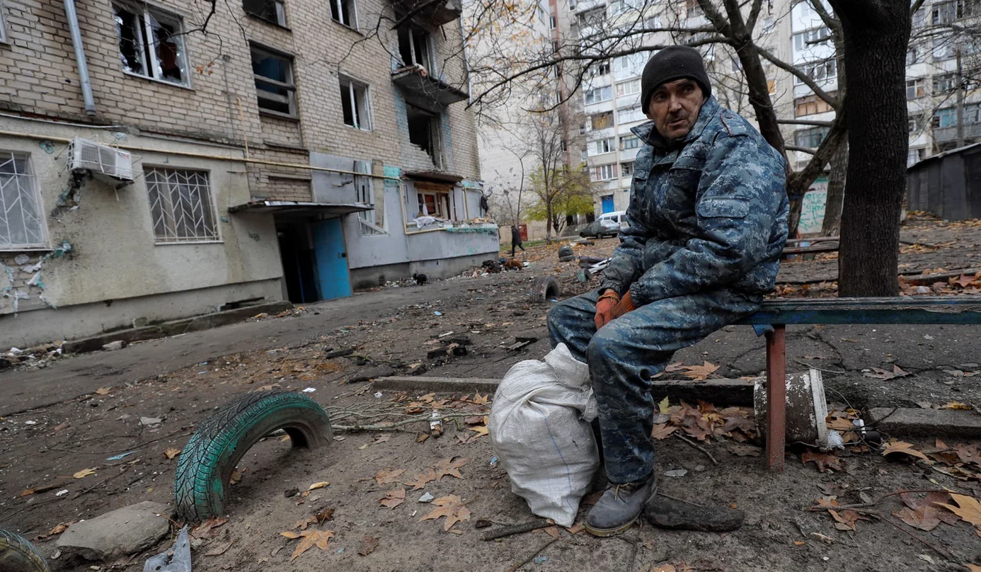 Oleksandr Antonenko sits in a front of his apartment building damaged by a recent Russian military strike in Kherson