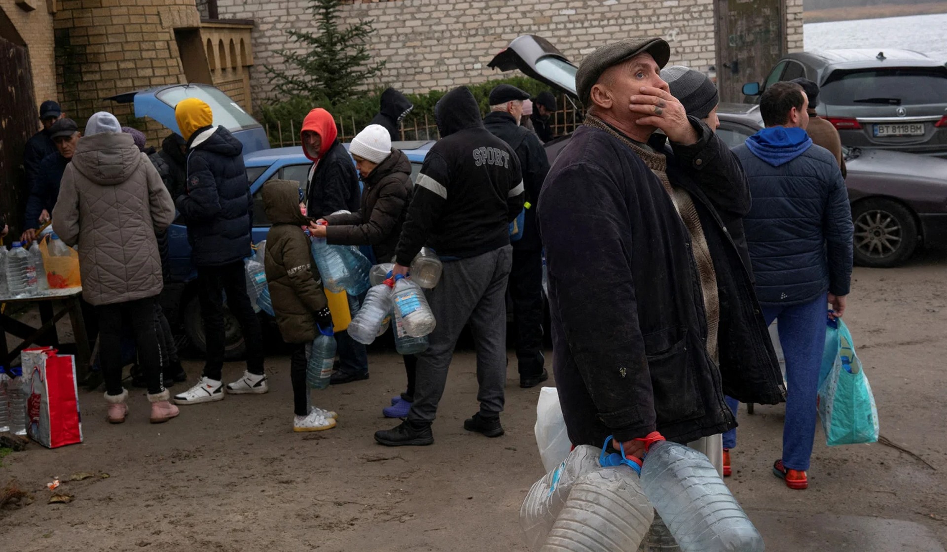 People fill up bottles with water near the Dnipro River after Russia's military retreat from Kherson