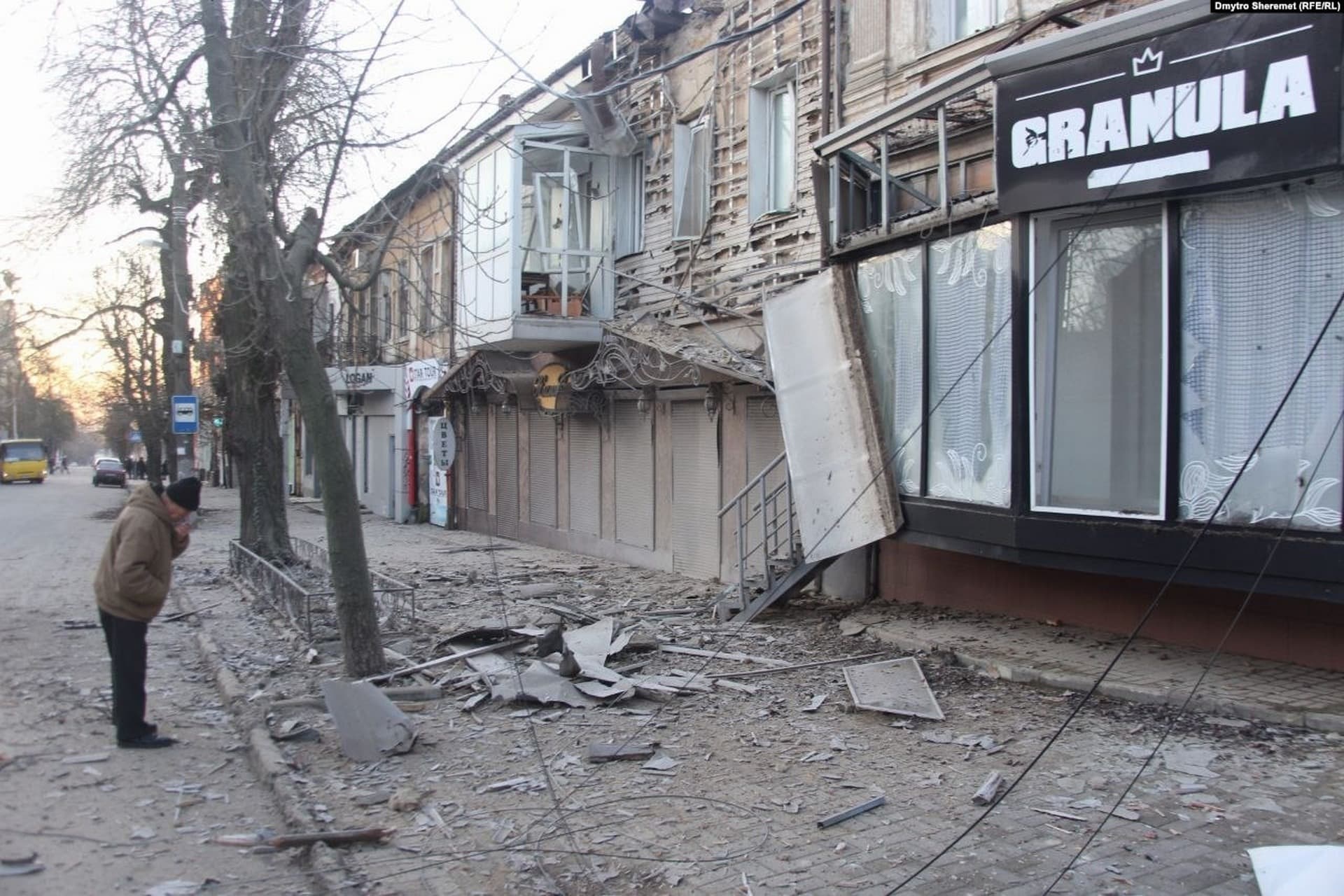 A man looks at the debris of shopfronts damaged in Russian shelling on the night of December 28