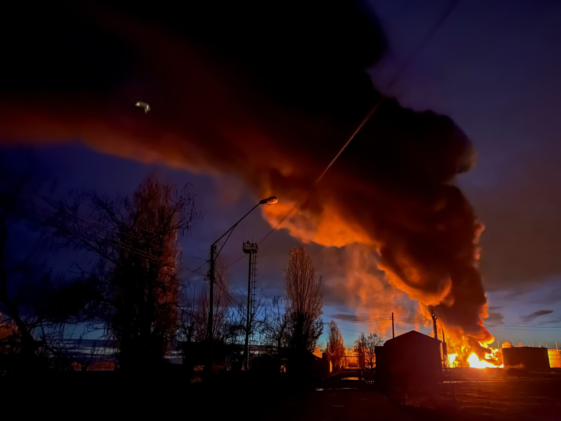 A plume of smoke rises during a fire caused by a Russian attack in Kherson