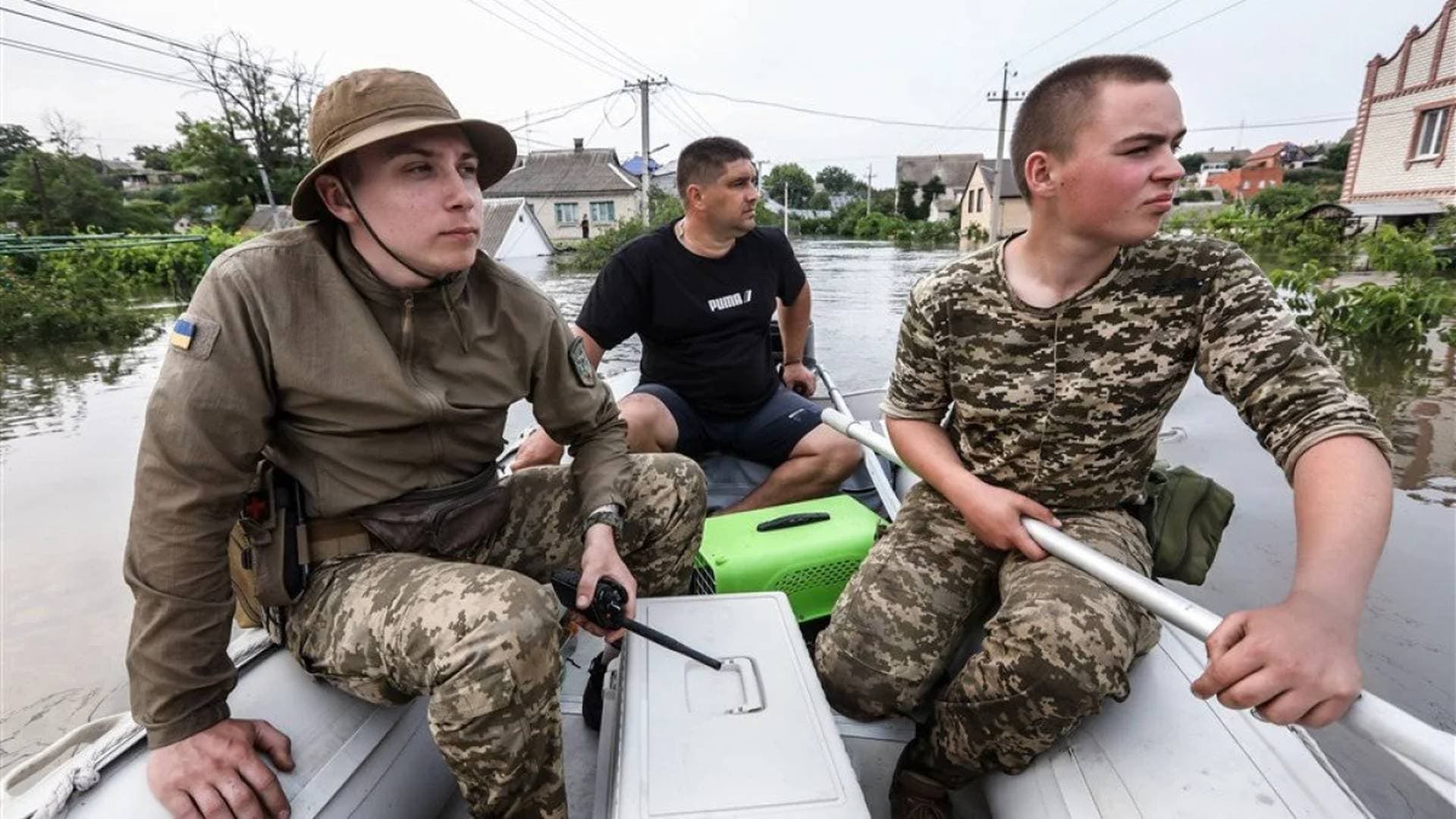 Ukrainian volunteers search for stranded animals in a flooded area of Kherson