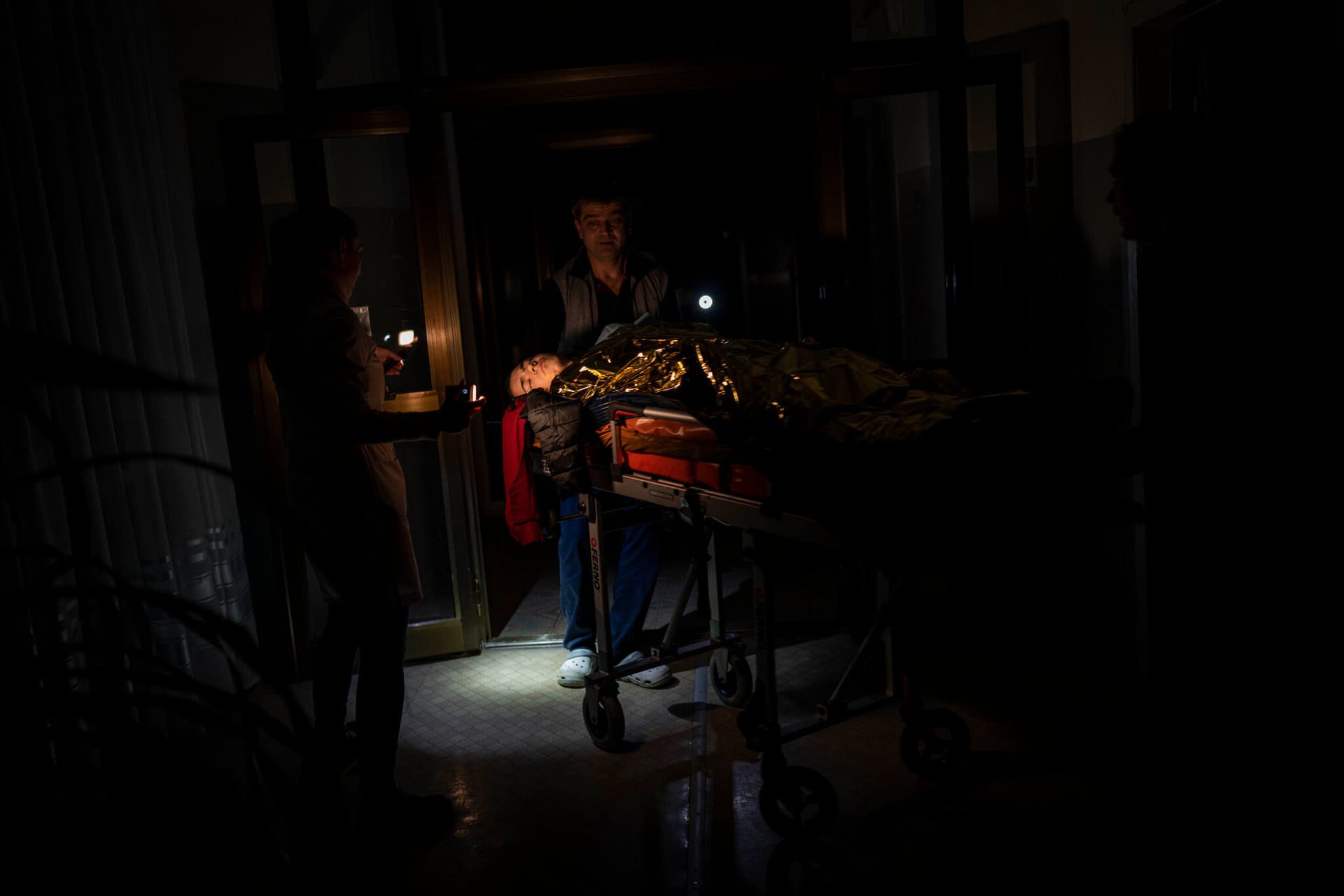 Staff move 13-year-old Arthur Voblikova to the operating room inside a hospital in Kherson