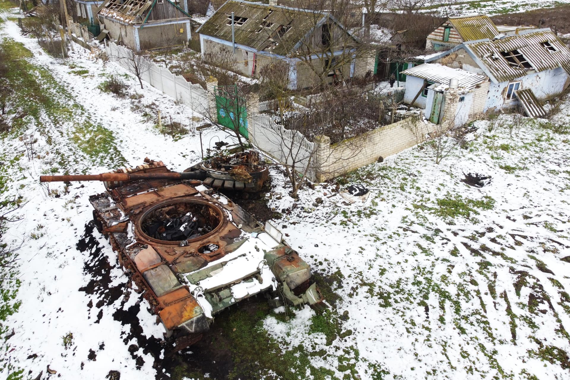 A destroyed Russian tank rusts near the Kovalyov brothers’ houses, near Posad-Pokrovske