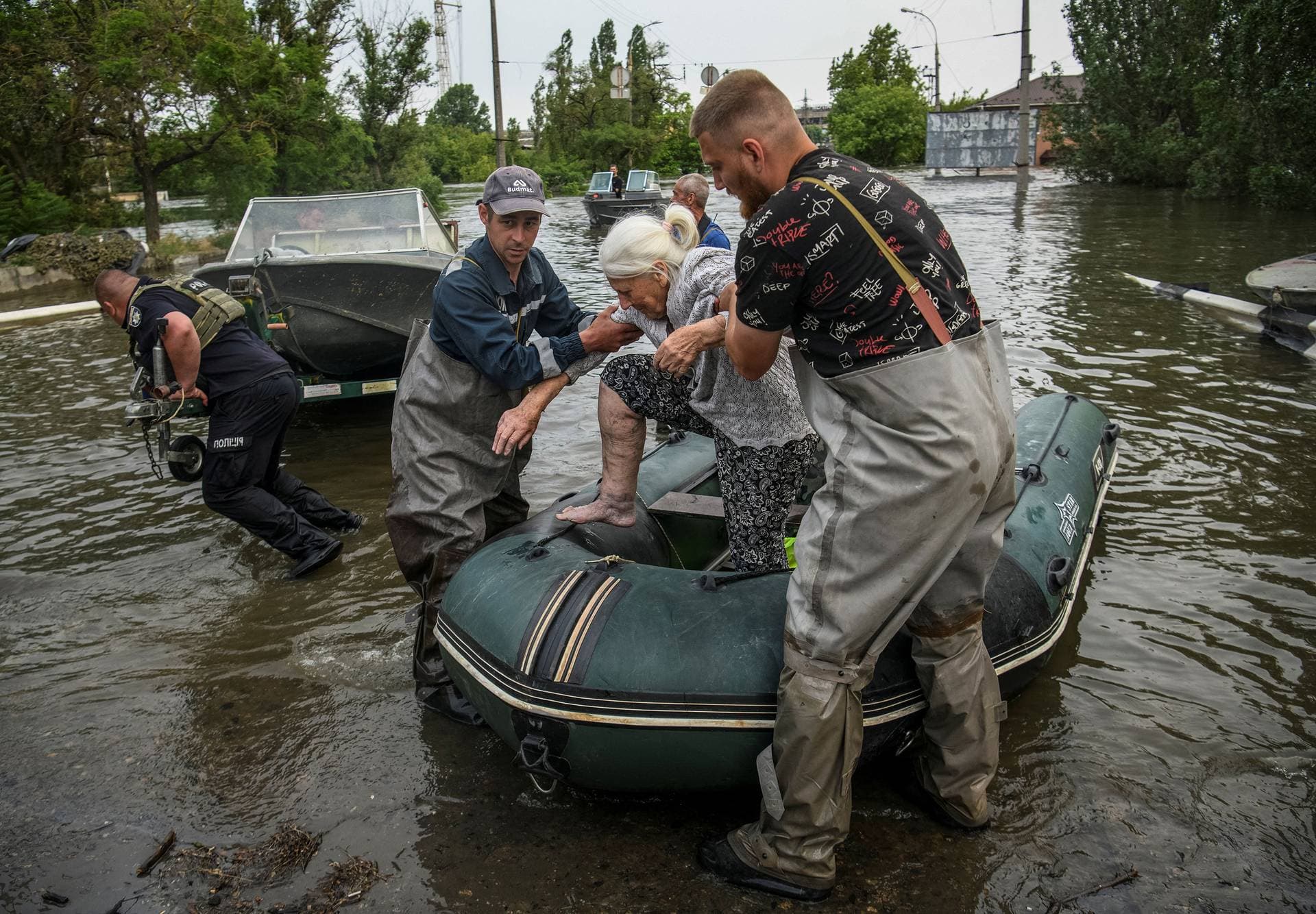 Rescuers evacuate a local resident from a flooded area in Kherson