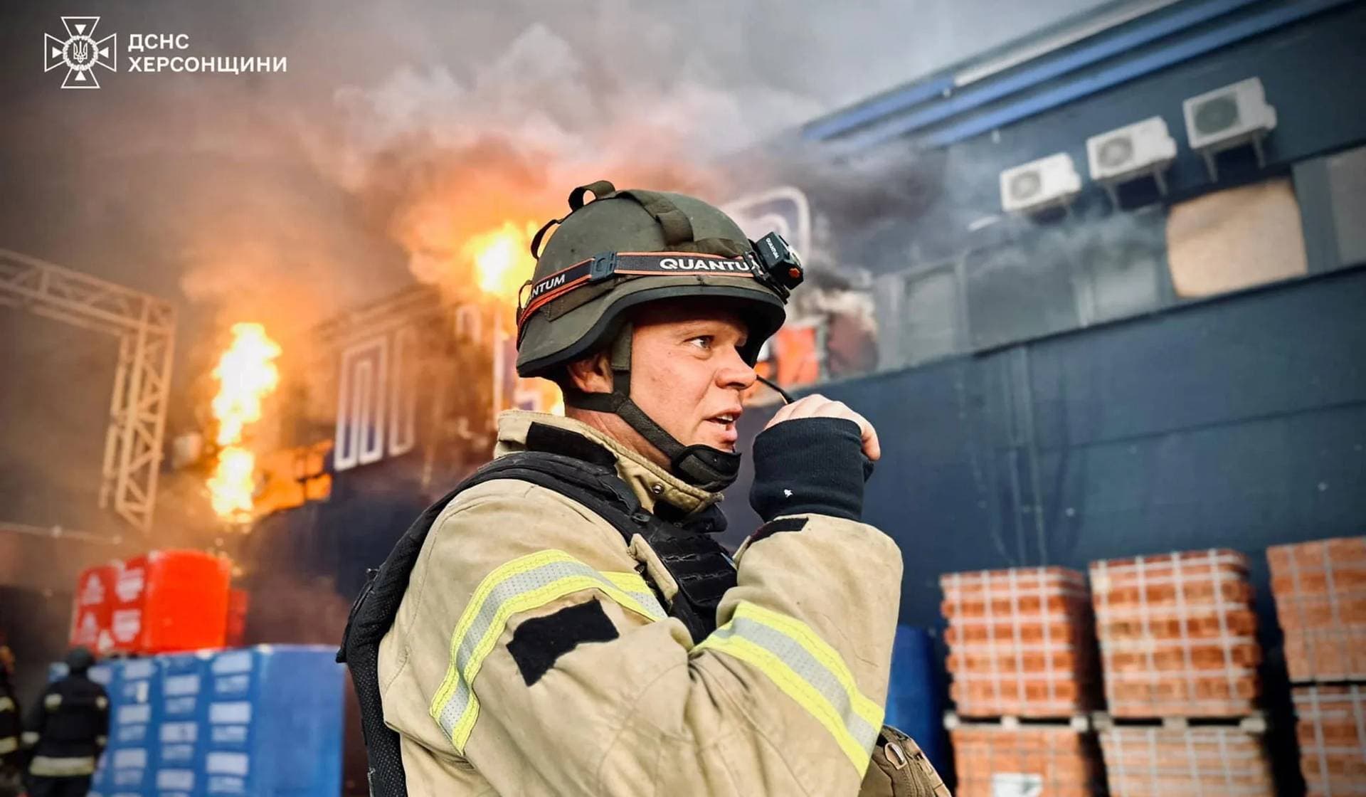 A firefighter works at the site of a household items shopping mall hit by a Russian military strike in Kherson