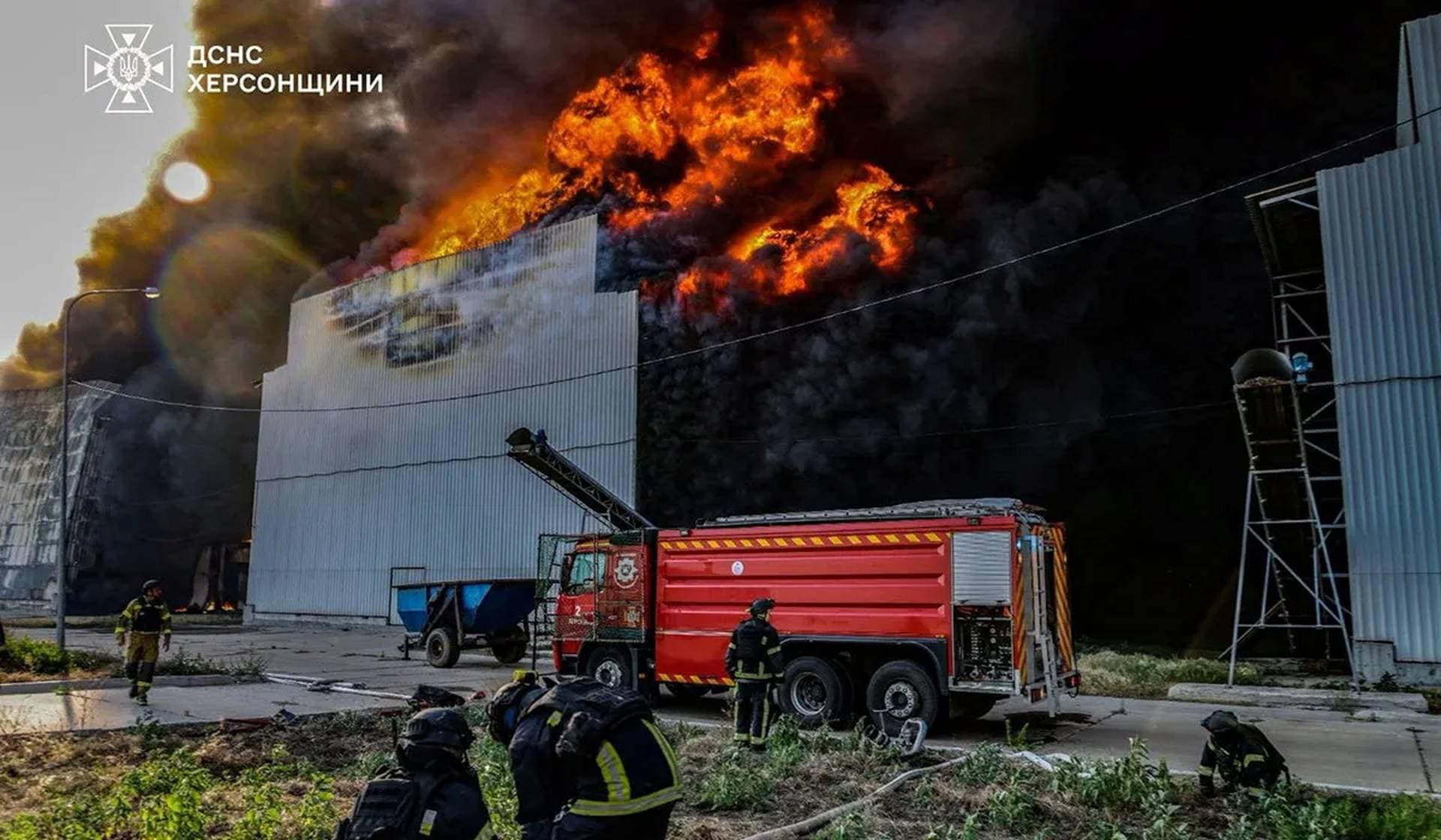 Firefighters work at the site of one of the biggest Ukrainian poultry farms in Chornobaivka in Kherson Region
