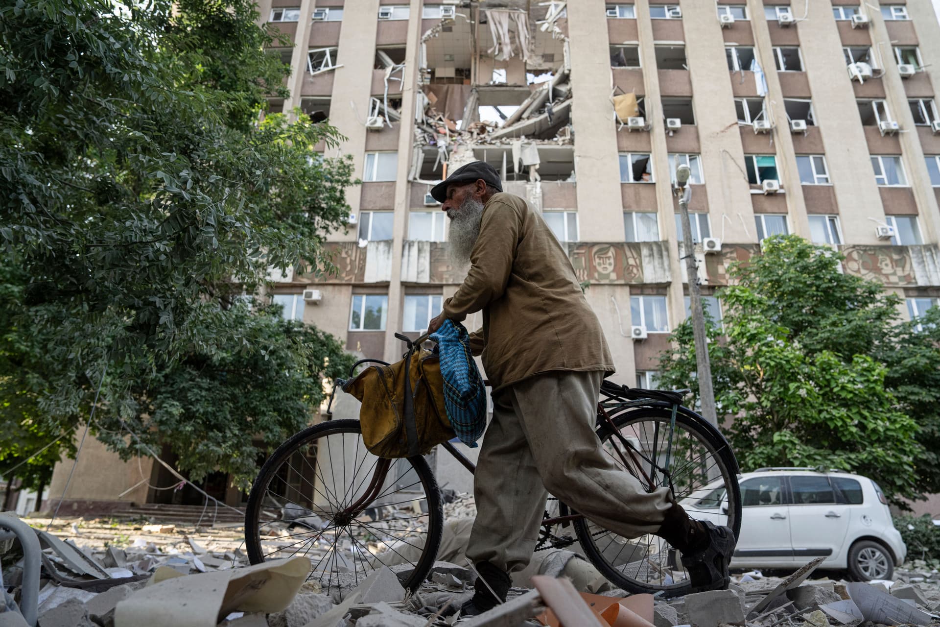 A man walks in front of a building which was heavily damaged by a Russian airstrike in Kherson