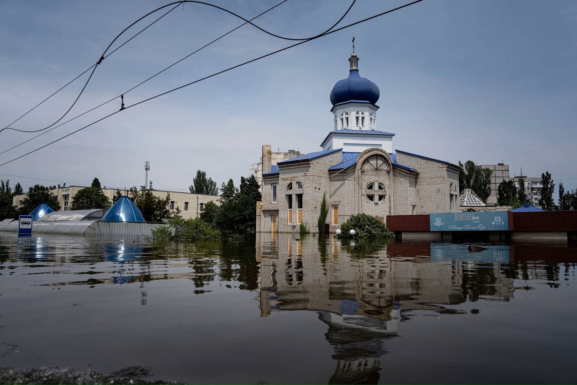 A church surrounded by water in a flooded neighborhood in Kherson