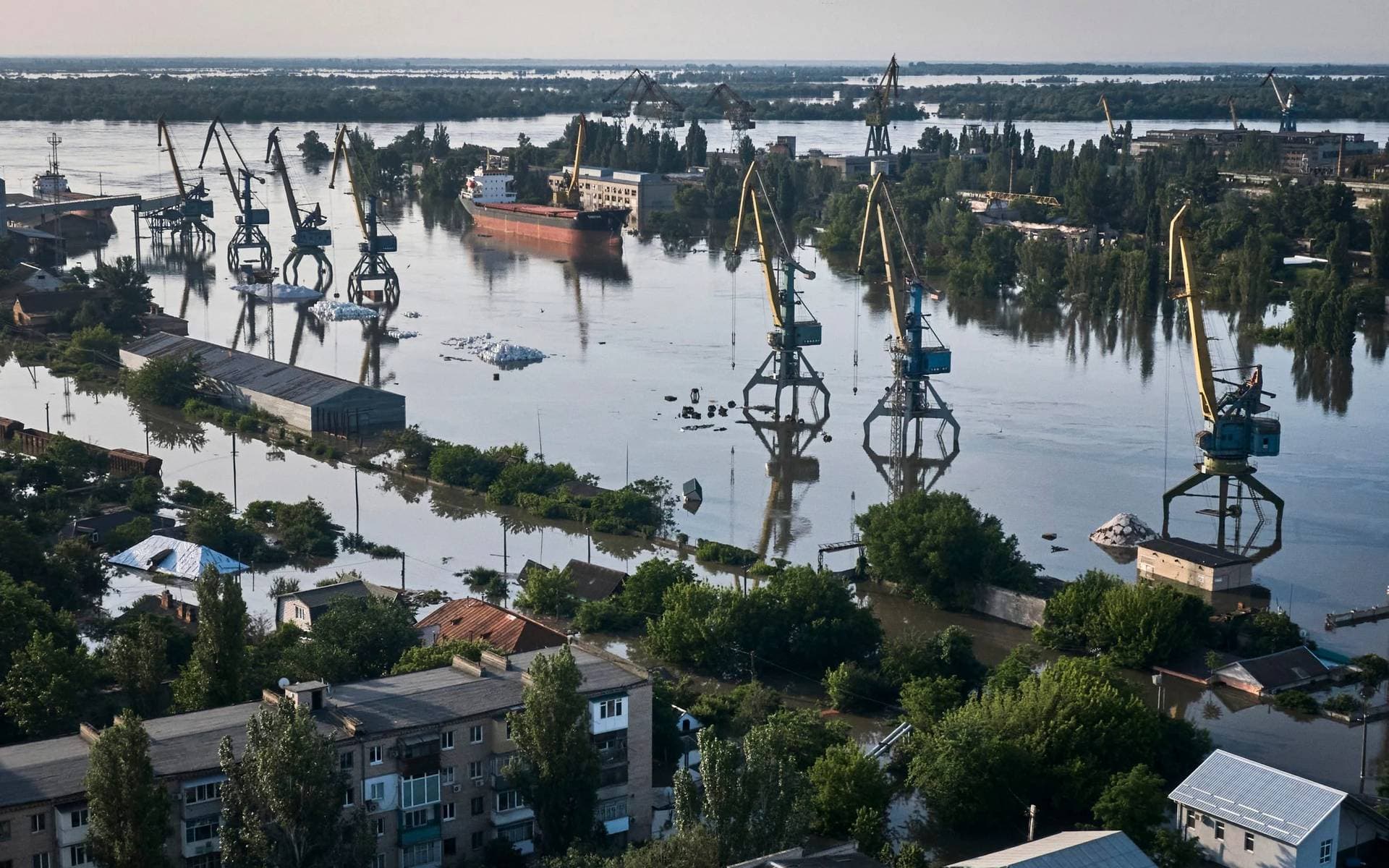 Streets in Kherson lie submerged in floodwater following the dam breach