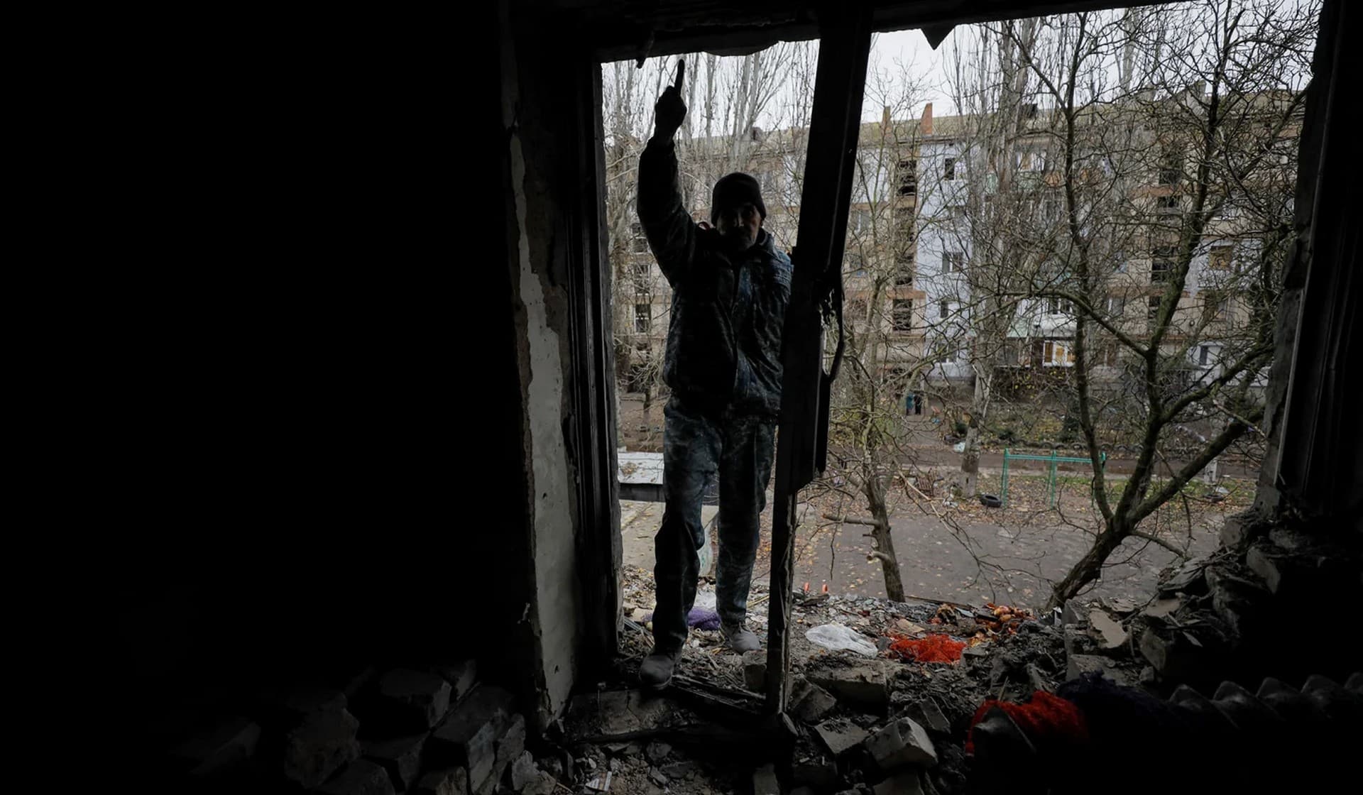 Oleksandr Antonenko stands on a balcony of his apartment damaged by a recent Russian military strike in Kherson
