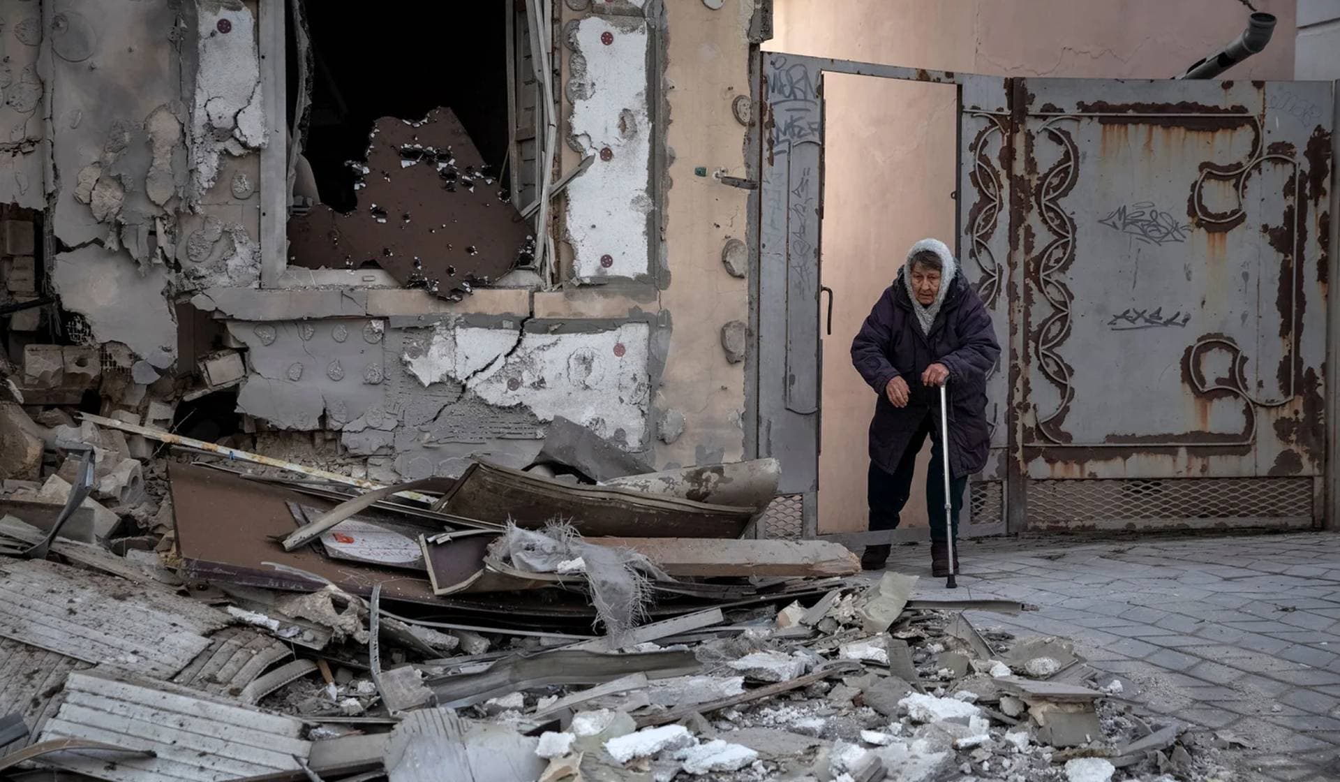 Local resident Klavdia, 82, stands near her house which was destroyed by a Russian military strike in Kherson