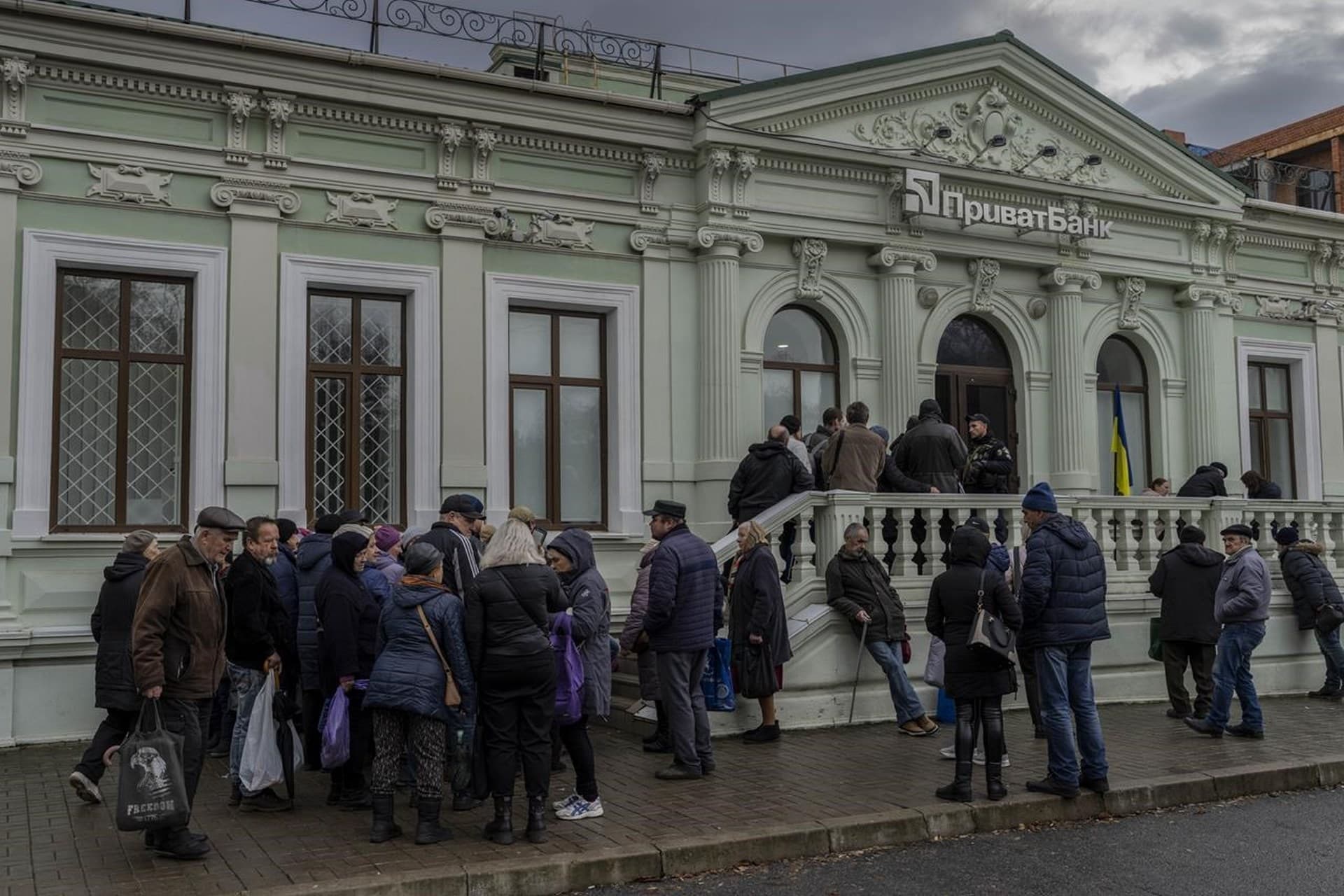 Residents queue at a bank branch in Kherson