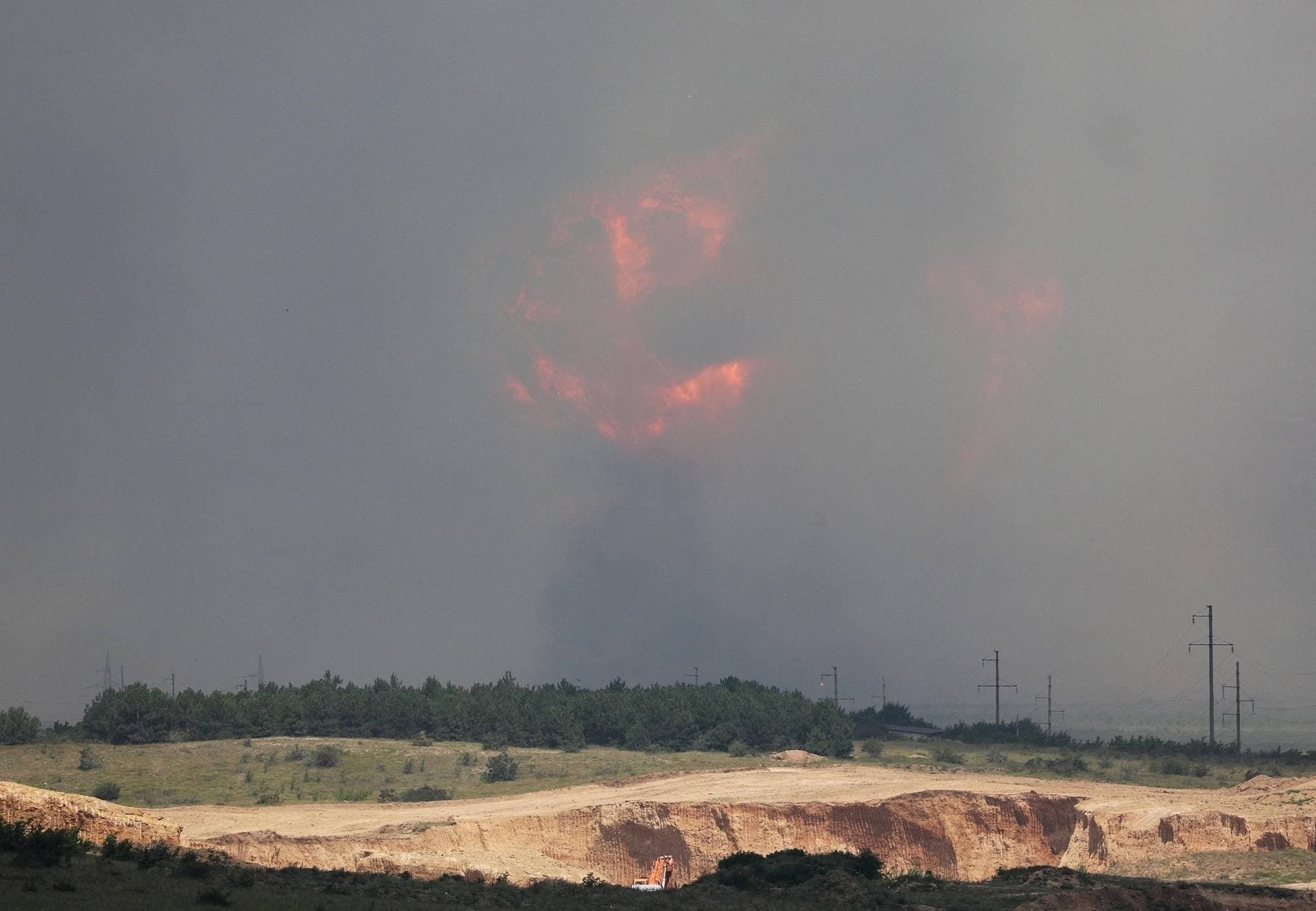 Smoke and flames rise from an explosion during a fire at a military training ground in Crimea’s Kirovsky district