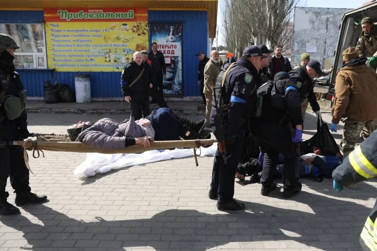 Emergency personnel tend to wounded in the aftermath of a rocket attack on the railway station in Kramatorsk.