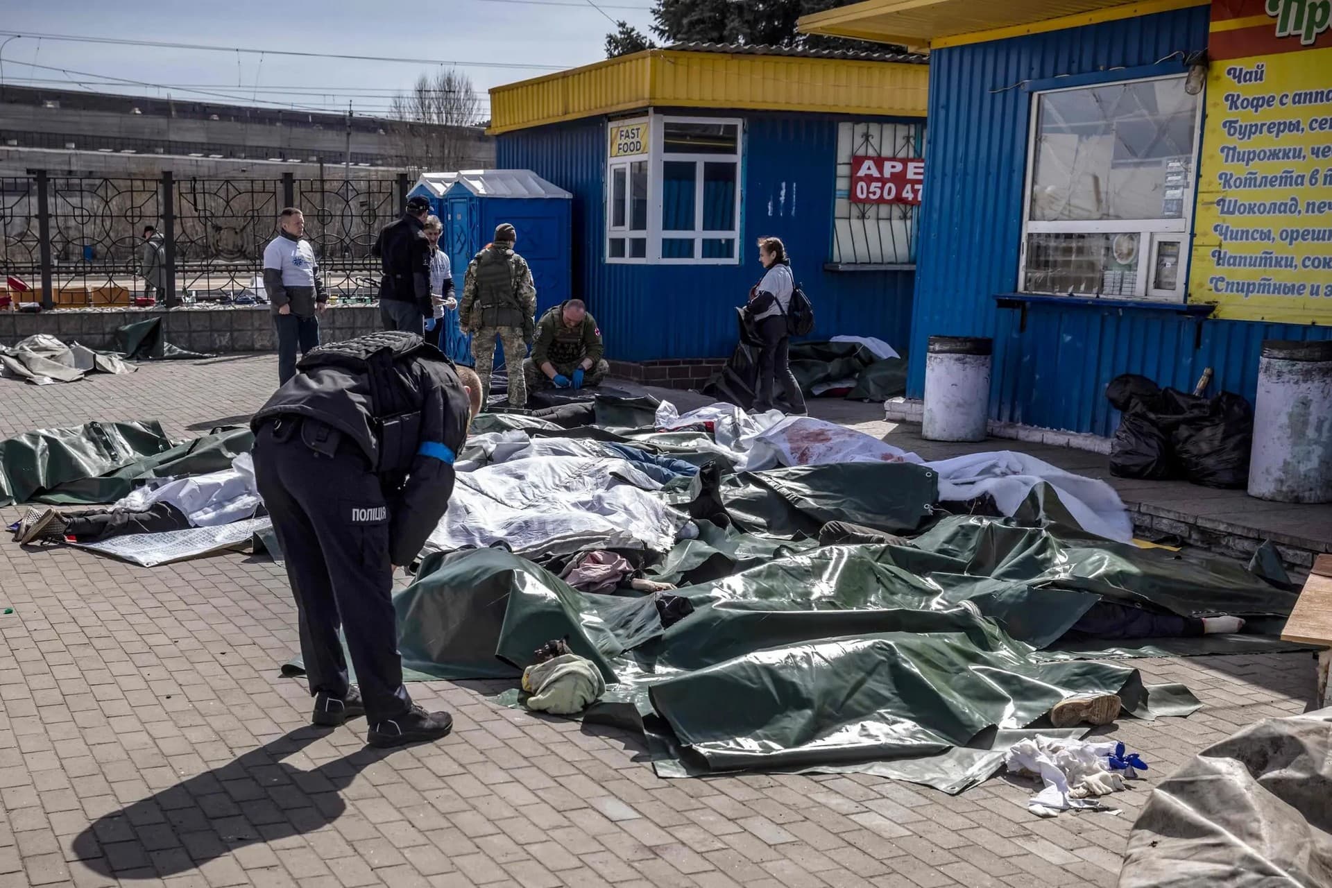 Bodies were covered with tarps after a rocket attack on a train station in Kramatorsk