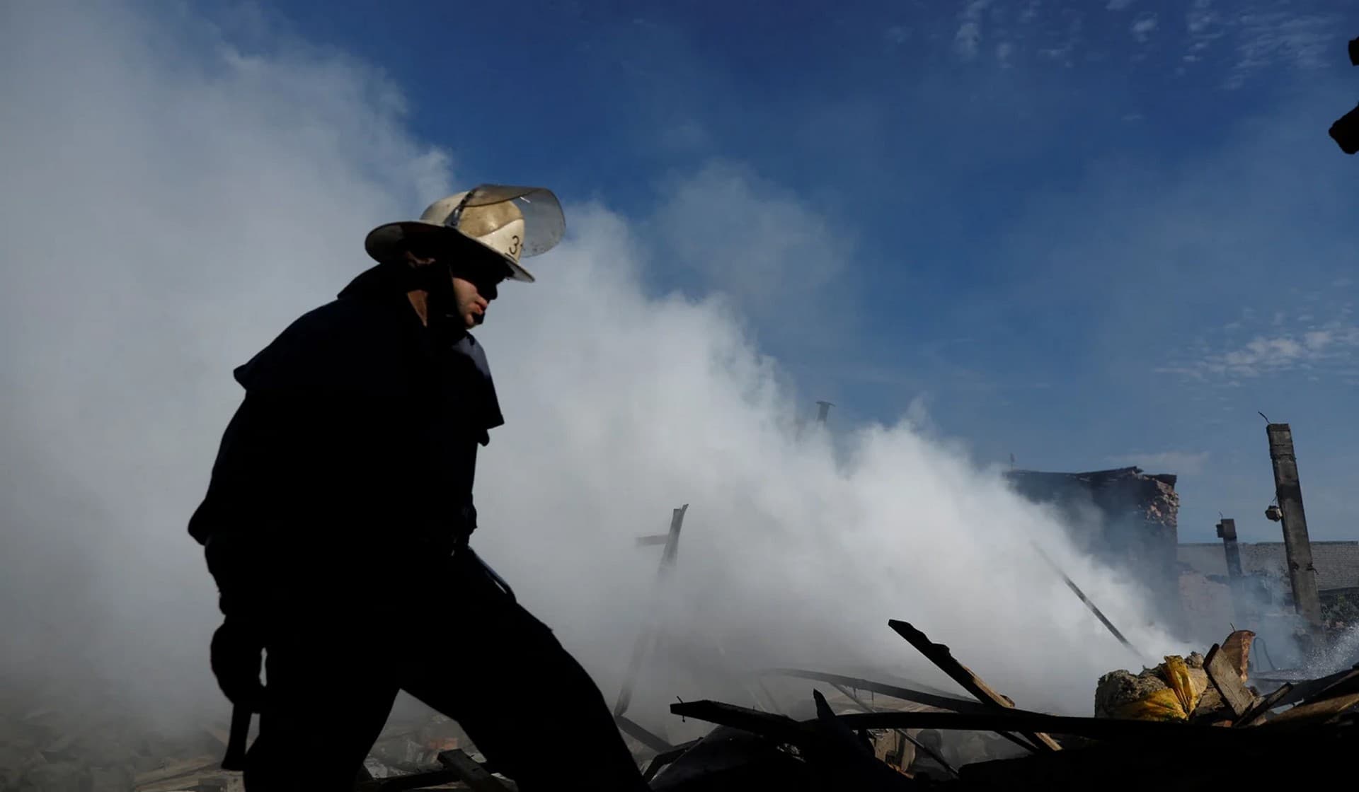 A Ukrainian firefighter puts out fire in a destroyed wholesale market after a Russian strike in Kramatorsk