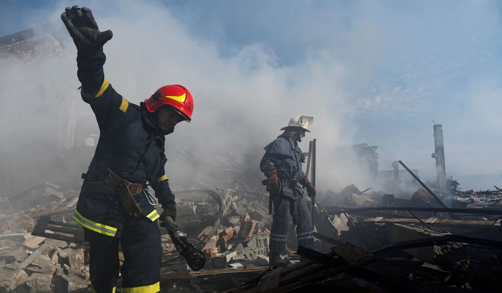 A Ukrainian firefighter puts out fire in a destroyed wholesale market after a Russian strike in Kramatorsk