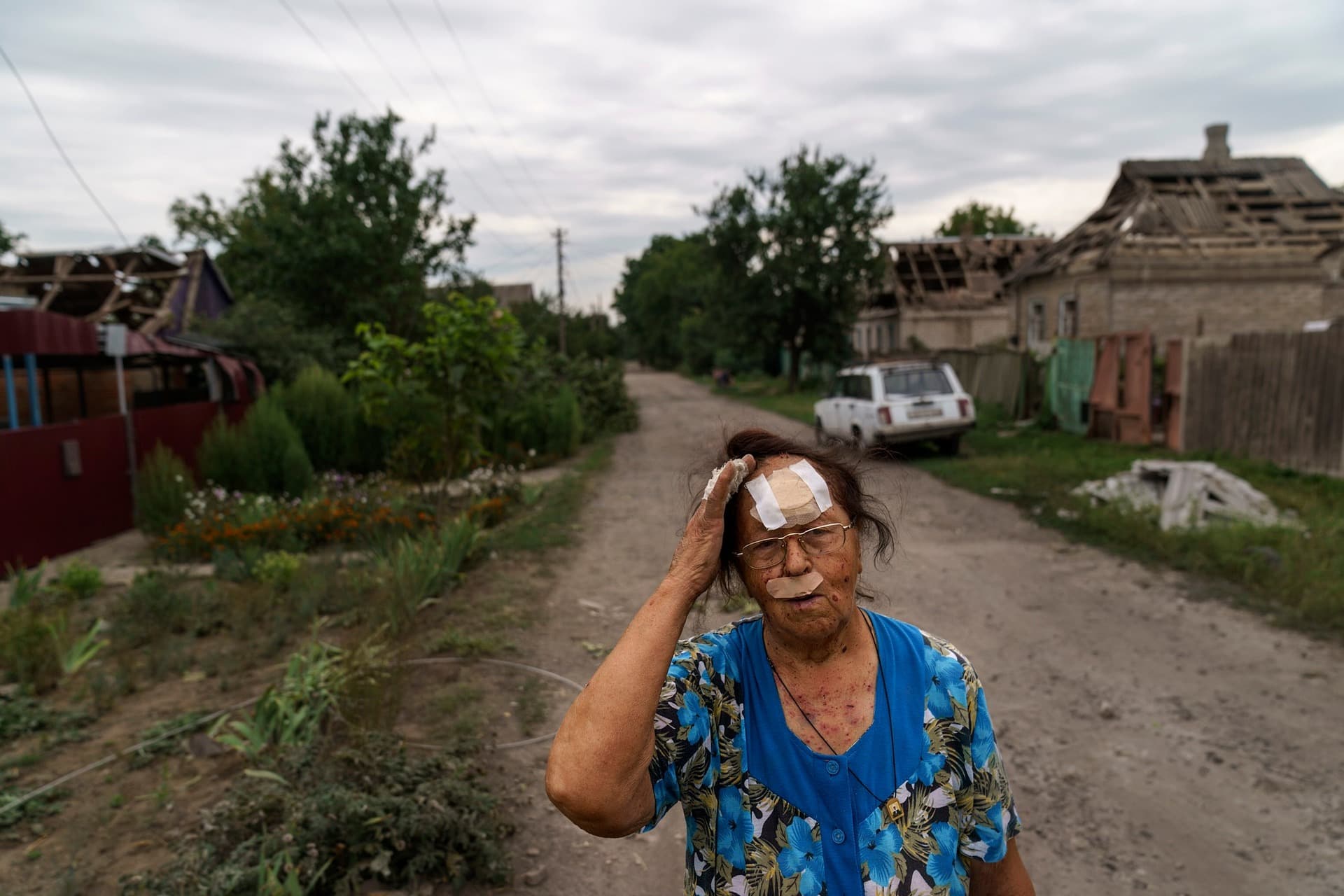 Valentyna Kondratieva stands outside her damaged home Saturday, Aug. 13, 2022 in Kramatorsk