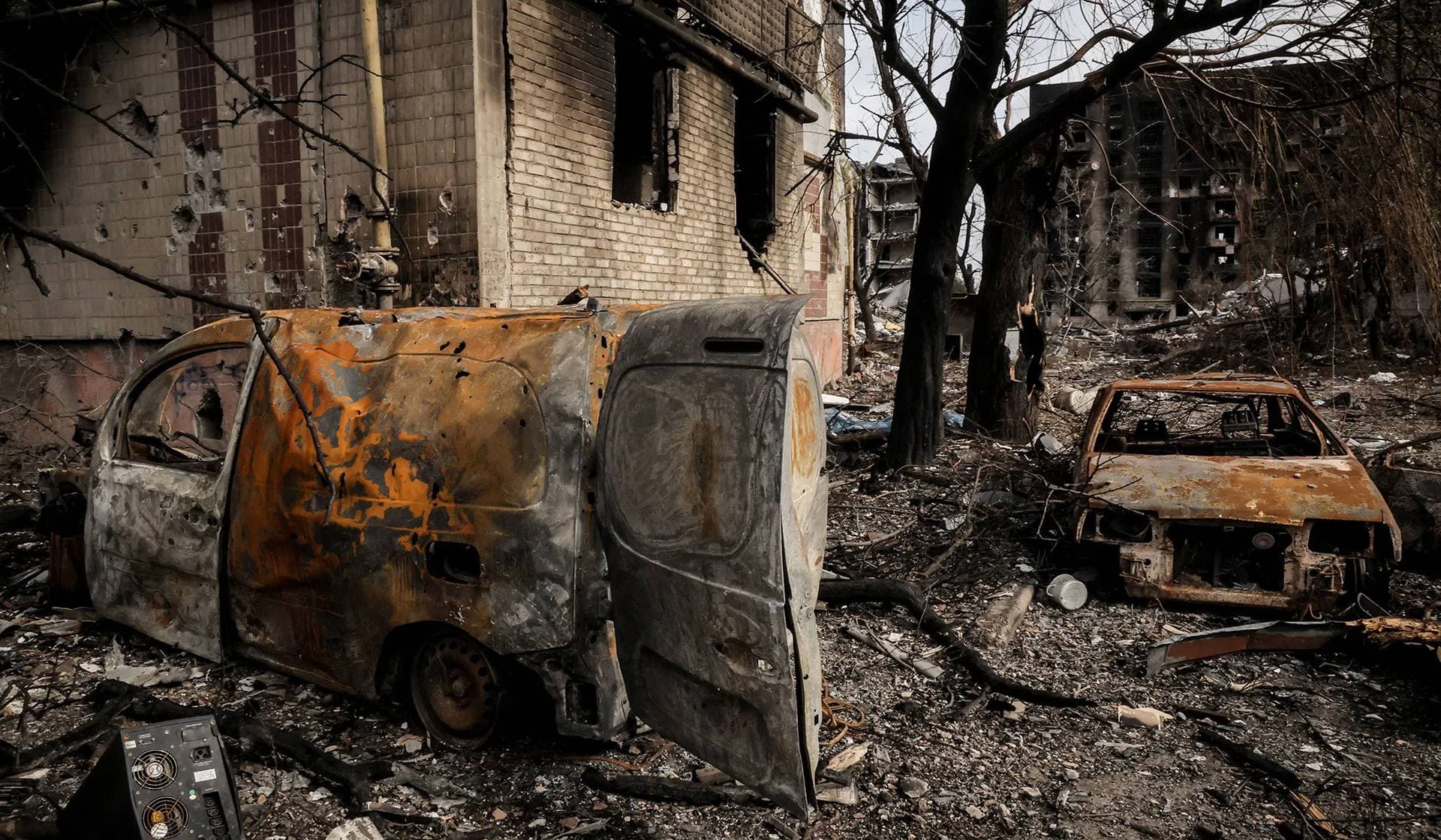 Destroyed cars lie near apartment buildings damaged by Russian military strike in the frontline town of Kostiantynivka
