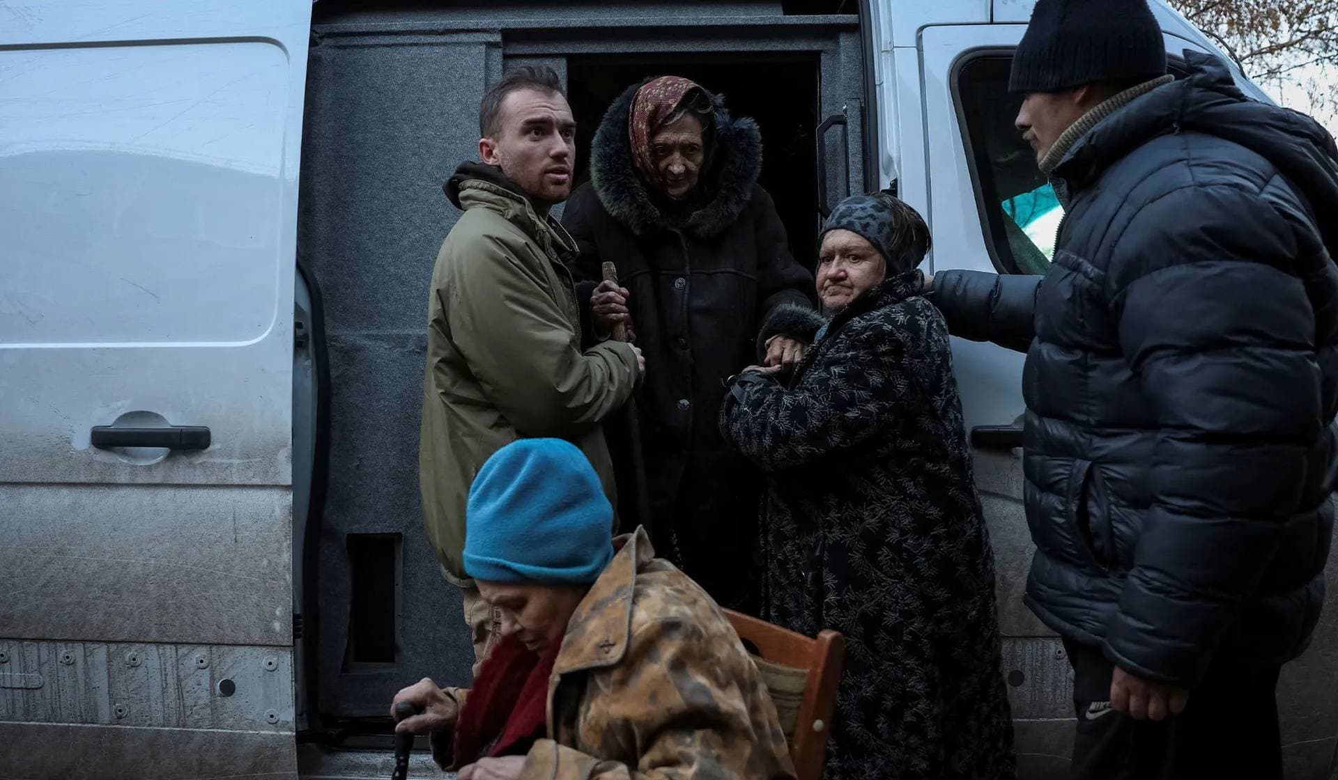 Residents exit an armored vehicle as Ukrainian police from the White Angel unit evacuate them from the frontline town of Kostiantynivka