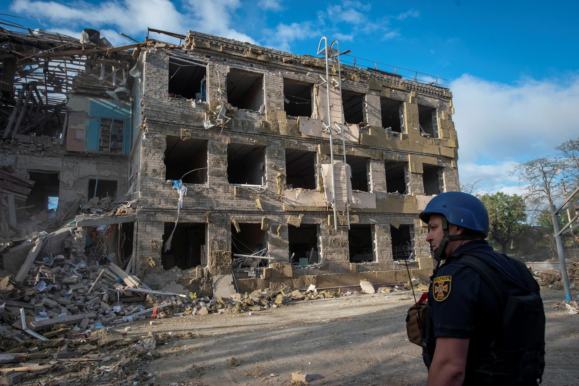 A rescuer stands in a front of a school building destroyed by a Russian attack, in Kramatorsk