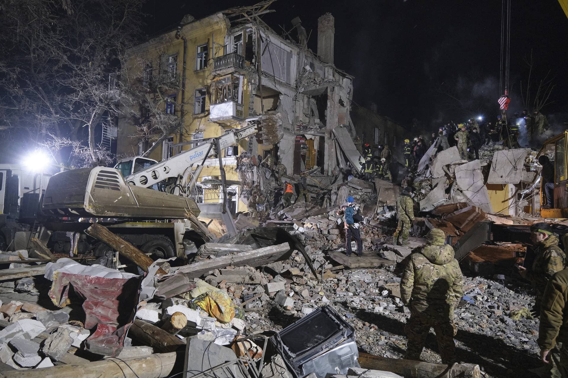 Emergency workers clear the rubble after a Russian rocket hit an apartment building in Kramatorsk