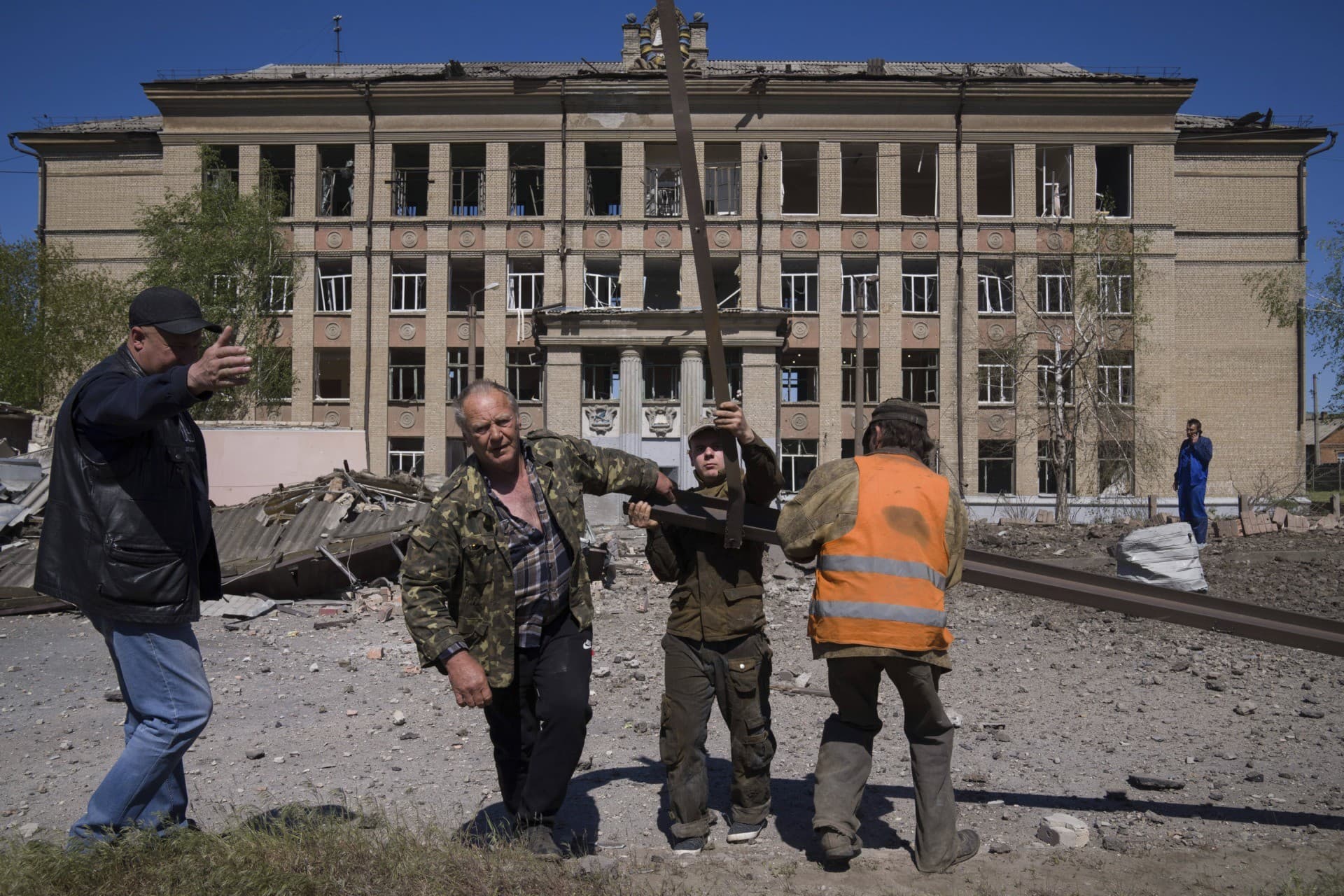People clean an area after Russian airstrike in Kostyantynivka