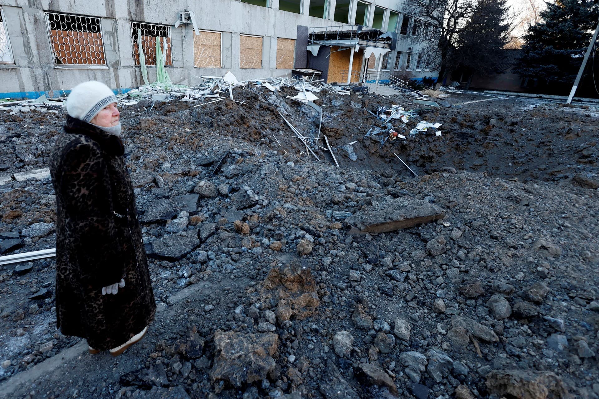 A woman looks at the site of a missile strike that occurred during the night in Kramatorsk