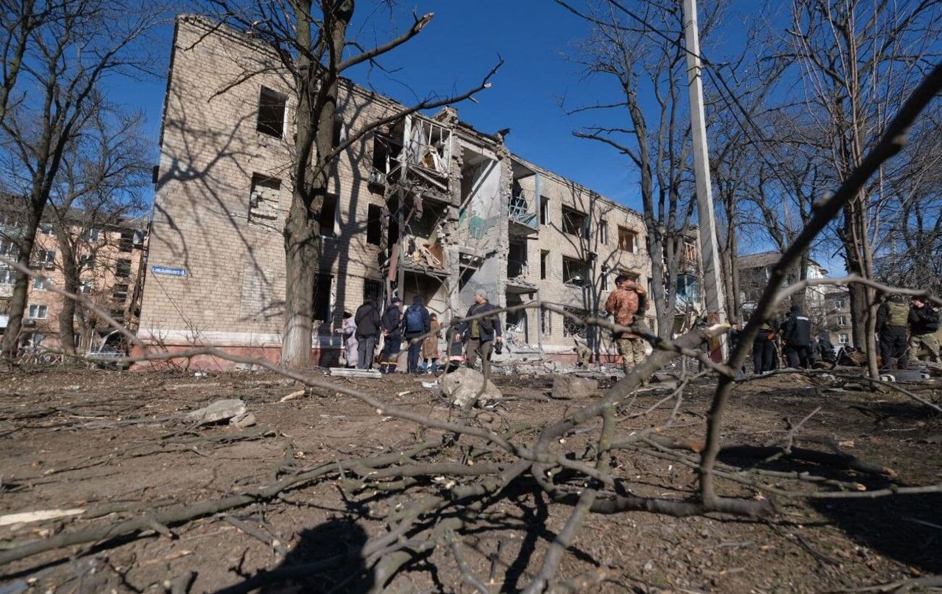 People attend the scene of a Russian missile strike on a residential building in Kramatorsk