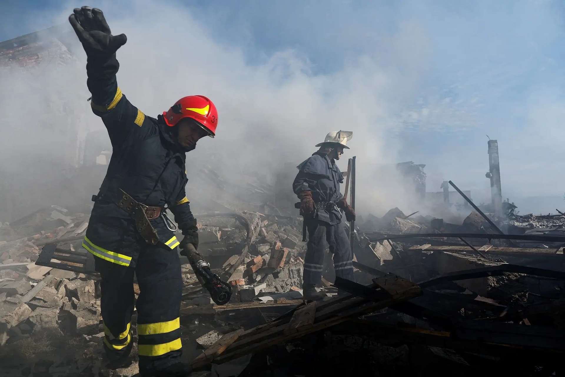 Ukrainian firefighters put out a blaze in a destroyed wholesale market after a Russian strike in Kramatorsk