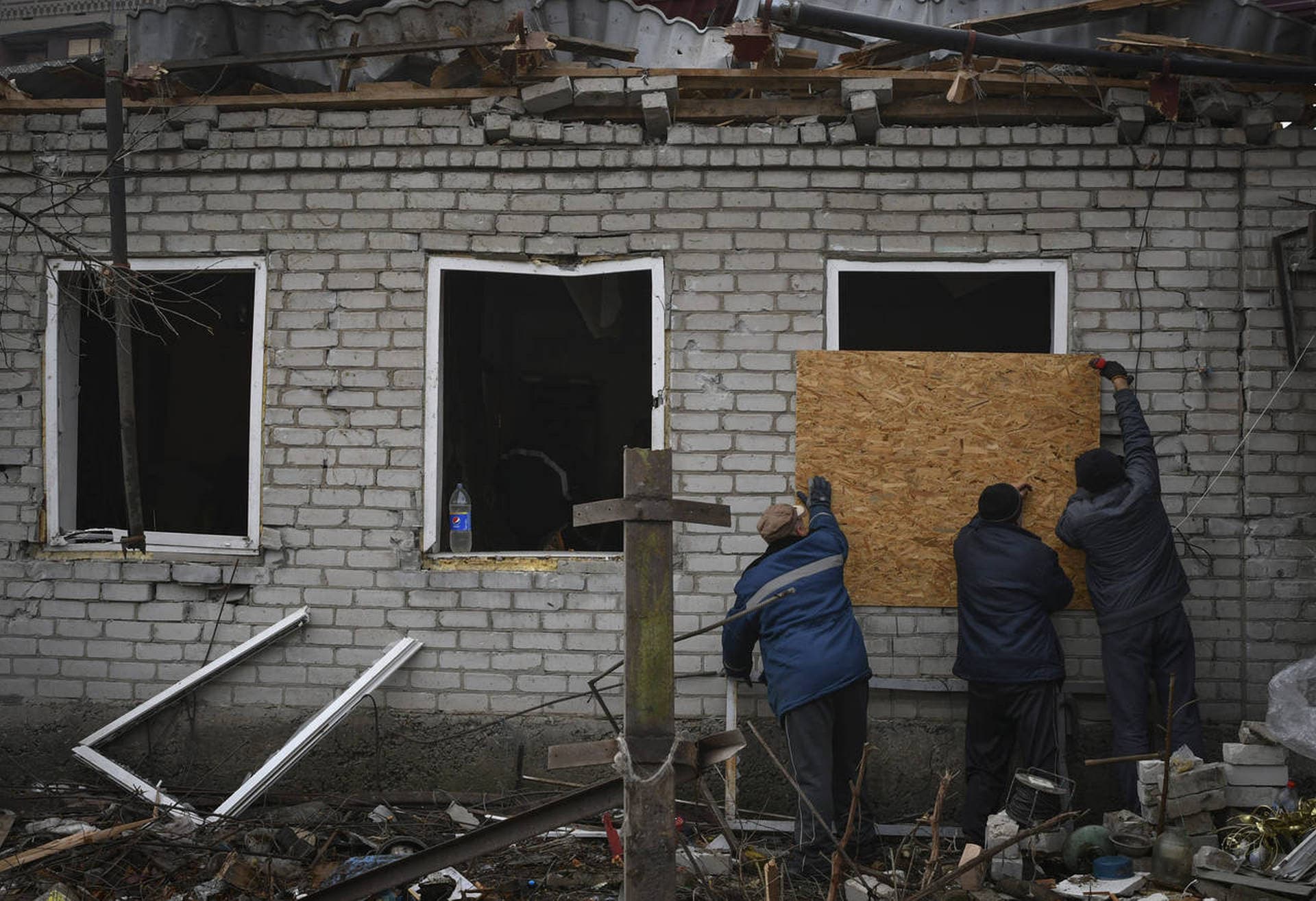Local residents board up broken windows after Russian shelling in Kramatorsk