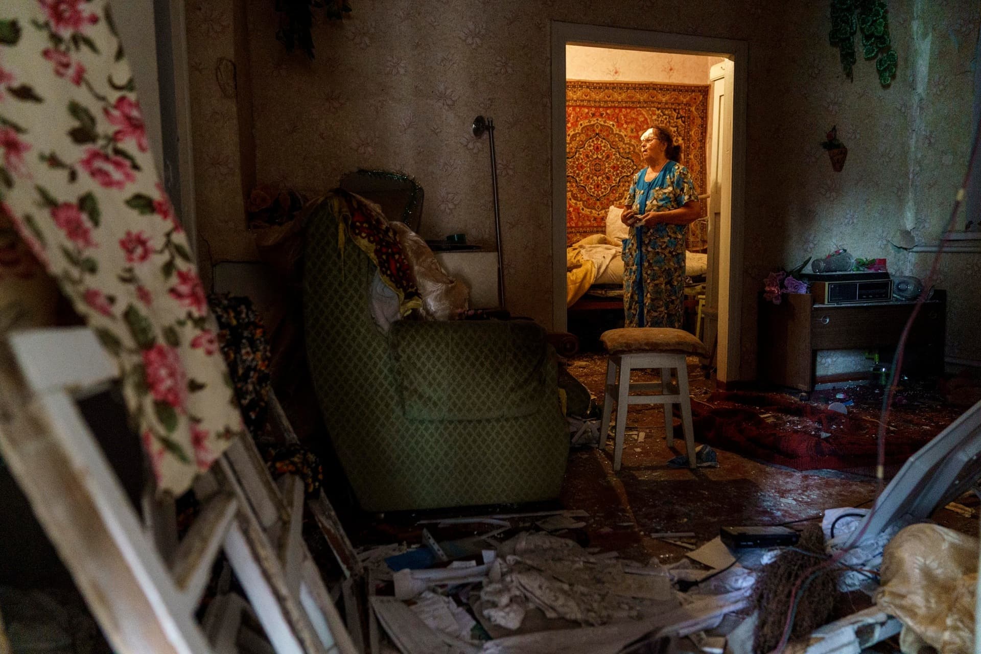 Valentyna Kondratieva stands inside her damaged home in Kramatorsk