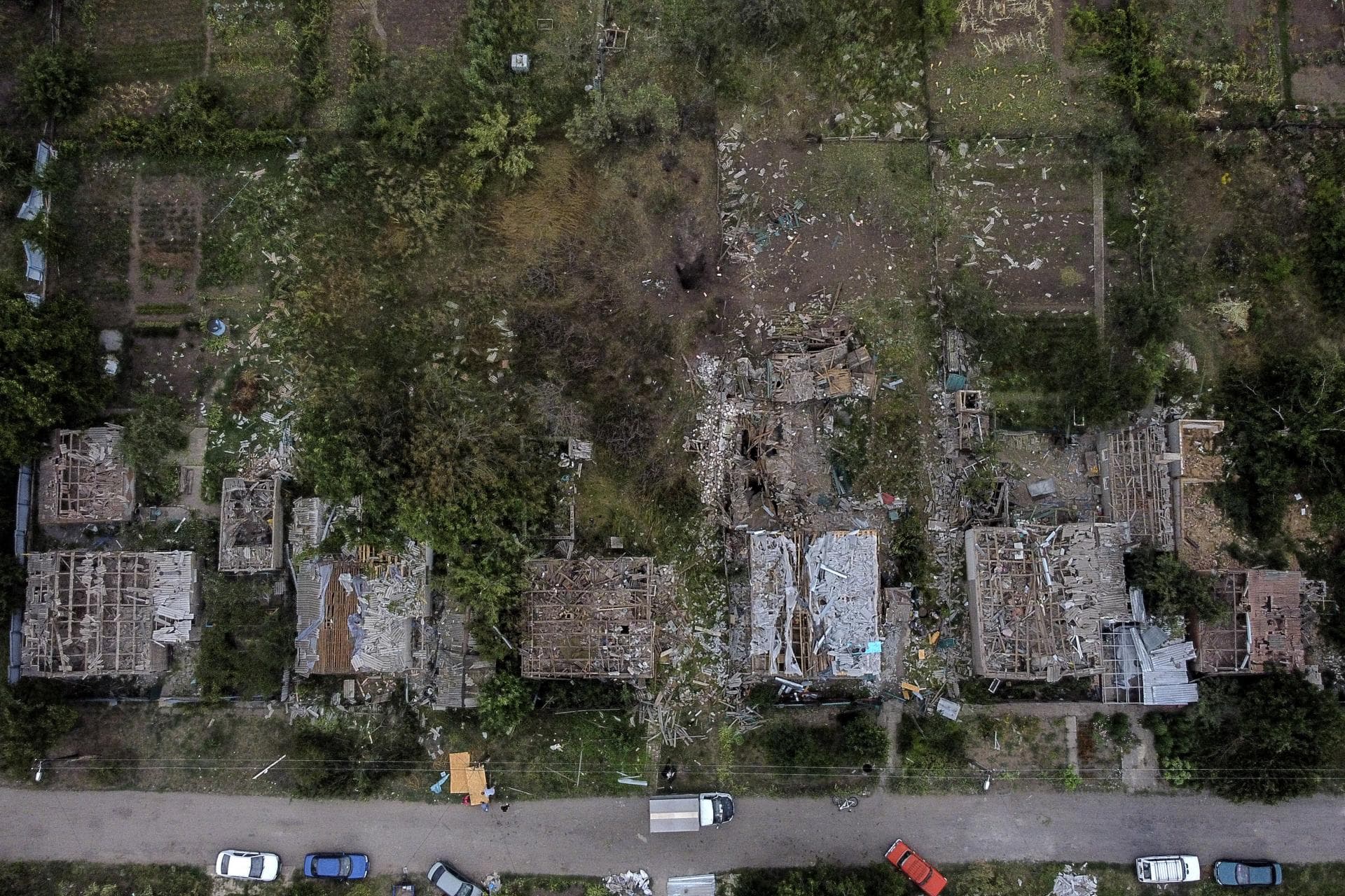A crater from a Russian rocket attack Friday night is seen next to damaged homes in Kramatorsk