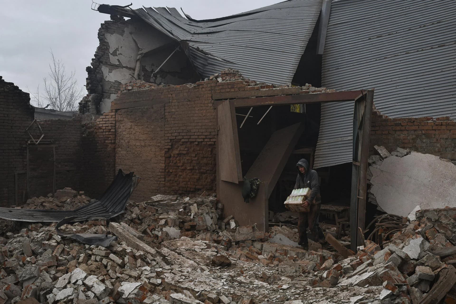 A local resident removes things after an overnight Russian attack in Kramatorsk