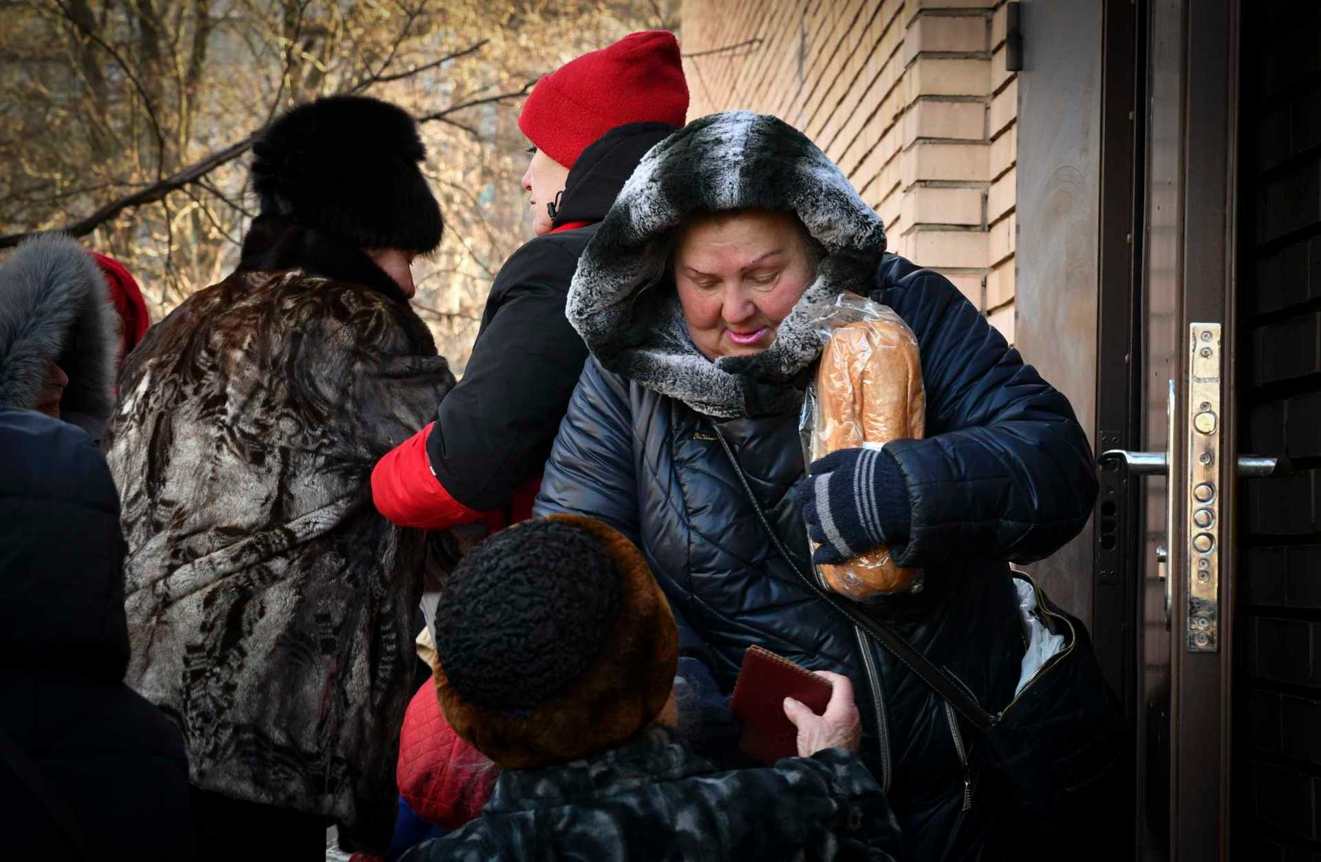People receive bread at humanitarian aid distribution spot in Kramatorsk