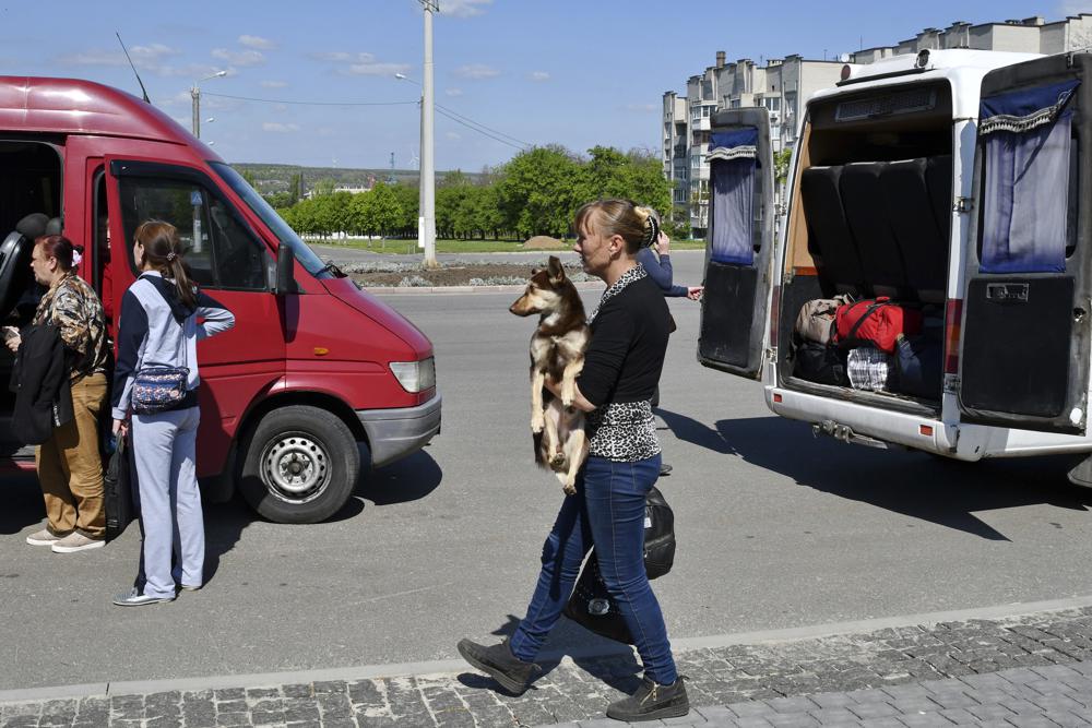 A woman holds her dog during an evacuation of civilians in Kramatorsk