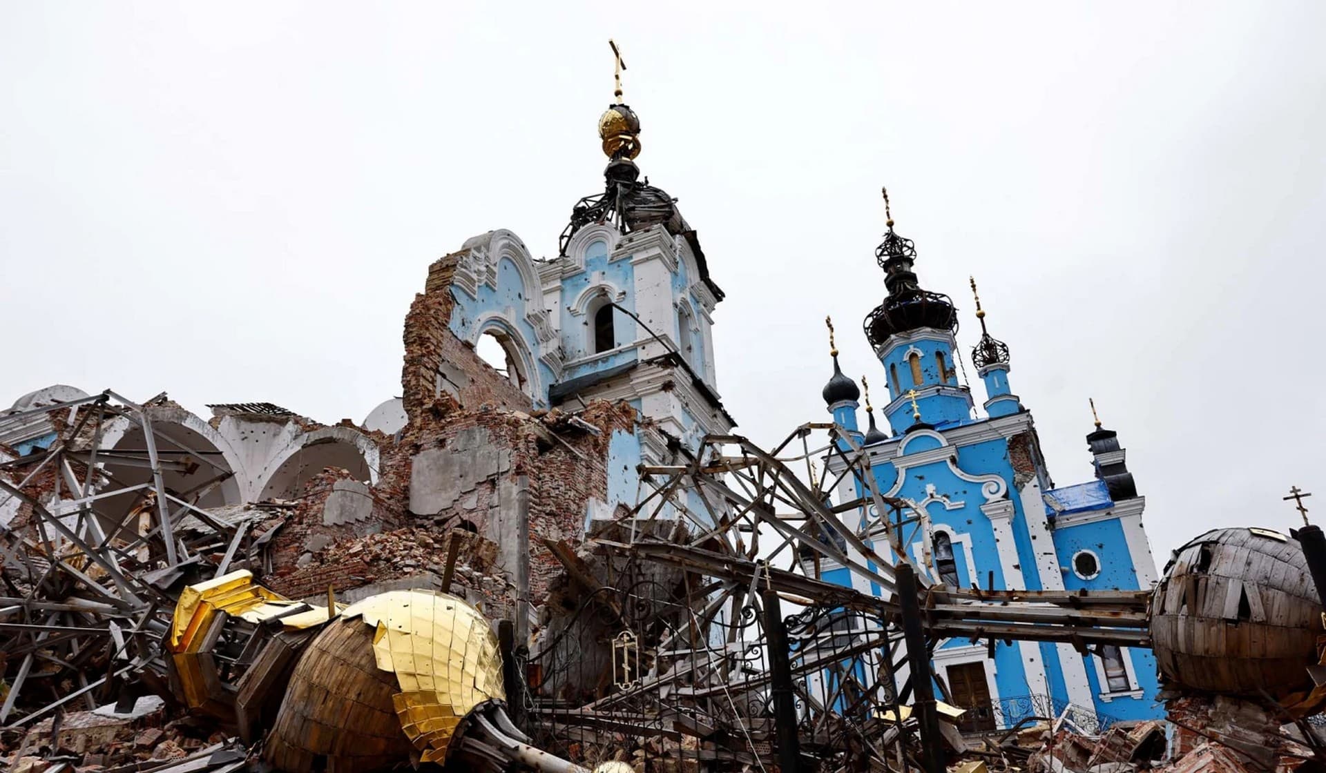The dome of an Orthodox Church lies next to its building, destroyed as a result of shelling in the village of Bohorodychne
