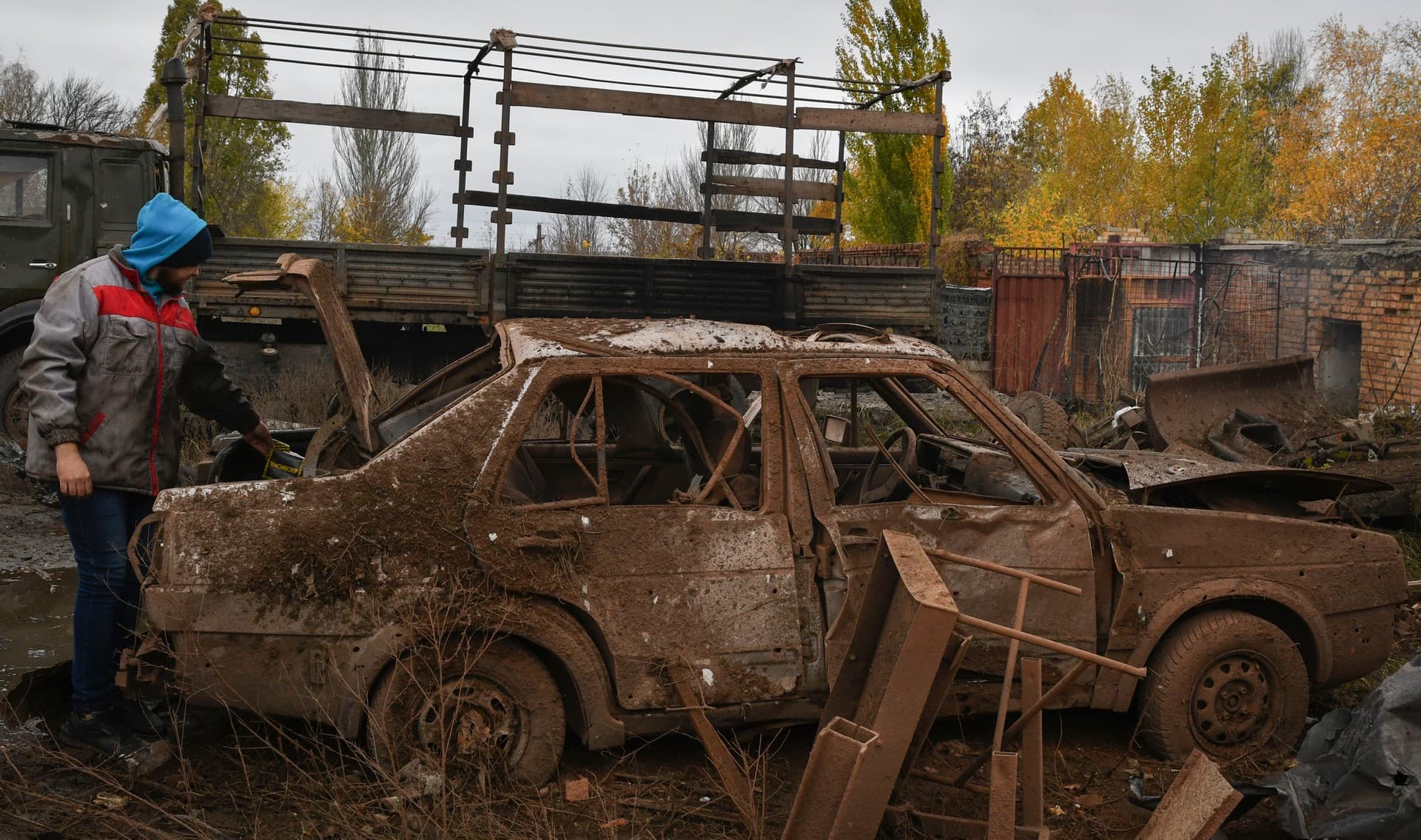 A local resident stands next to his car that was damaged after an overnight Russian attack in Kramatorsk