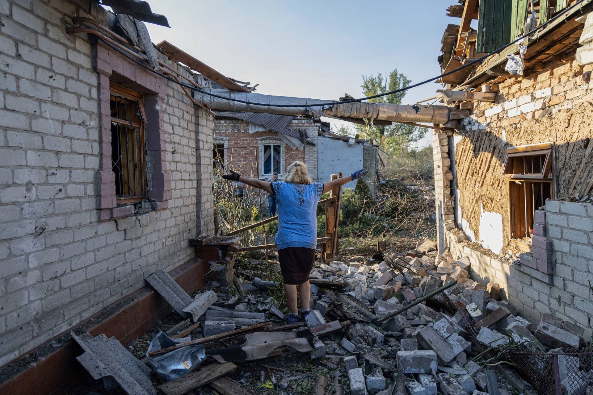 Olena Kononenko reacts near her damaged house after Russian rocket attack in Kostiantynivka