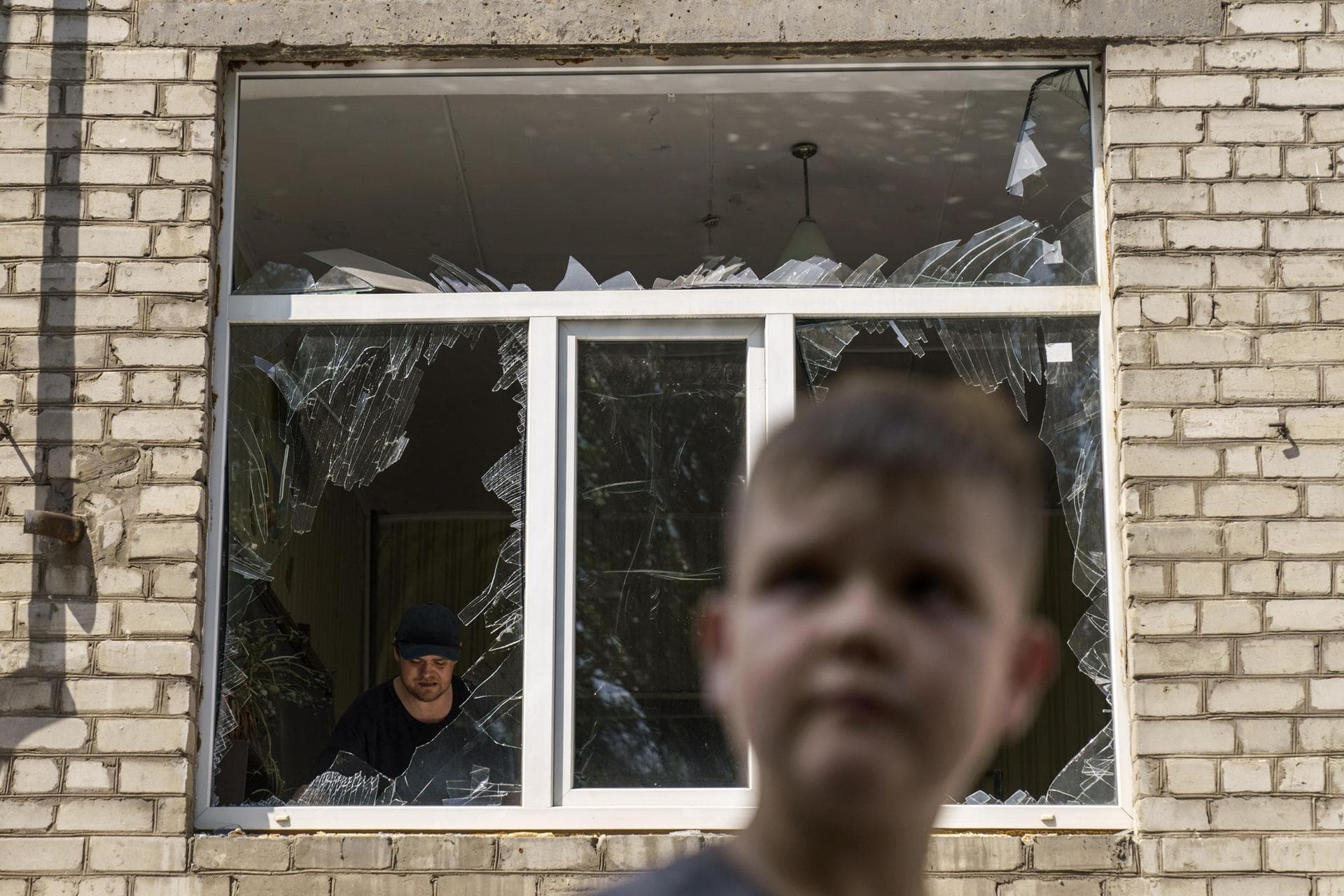 Tikhon Pavlov walks past the Kramatorsk College of Technologies and Design, where he used to take karate lessons, after an early morning rocket attack in Kramatorsk