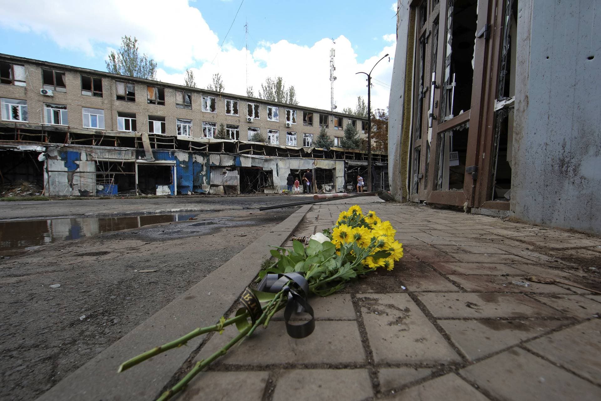 Flowers left by local residents to pay tribute to civilian people killed yesterday are seen at the strike site in Kostiantynivka
