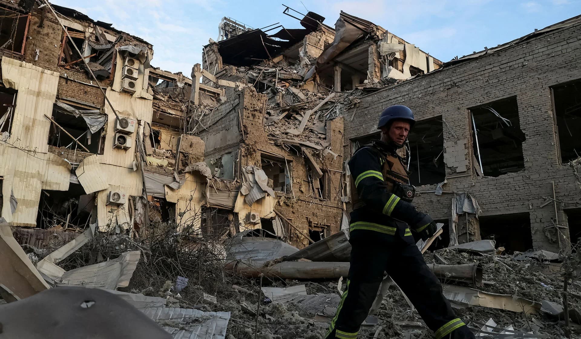 A rescuer works at a site of a building heavily damaged by a Russian missile strike in Kramatorsk