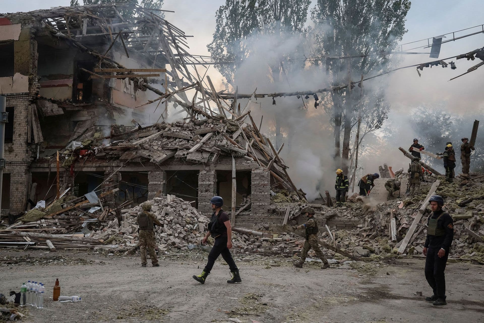 Rescuers and servicemen work at a damaged school building in Kramatorsk