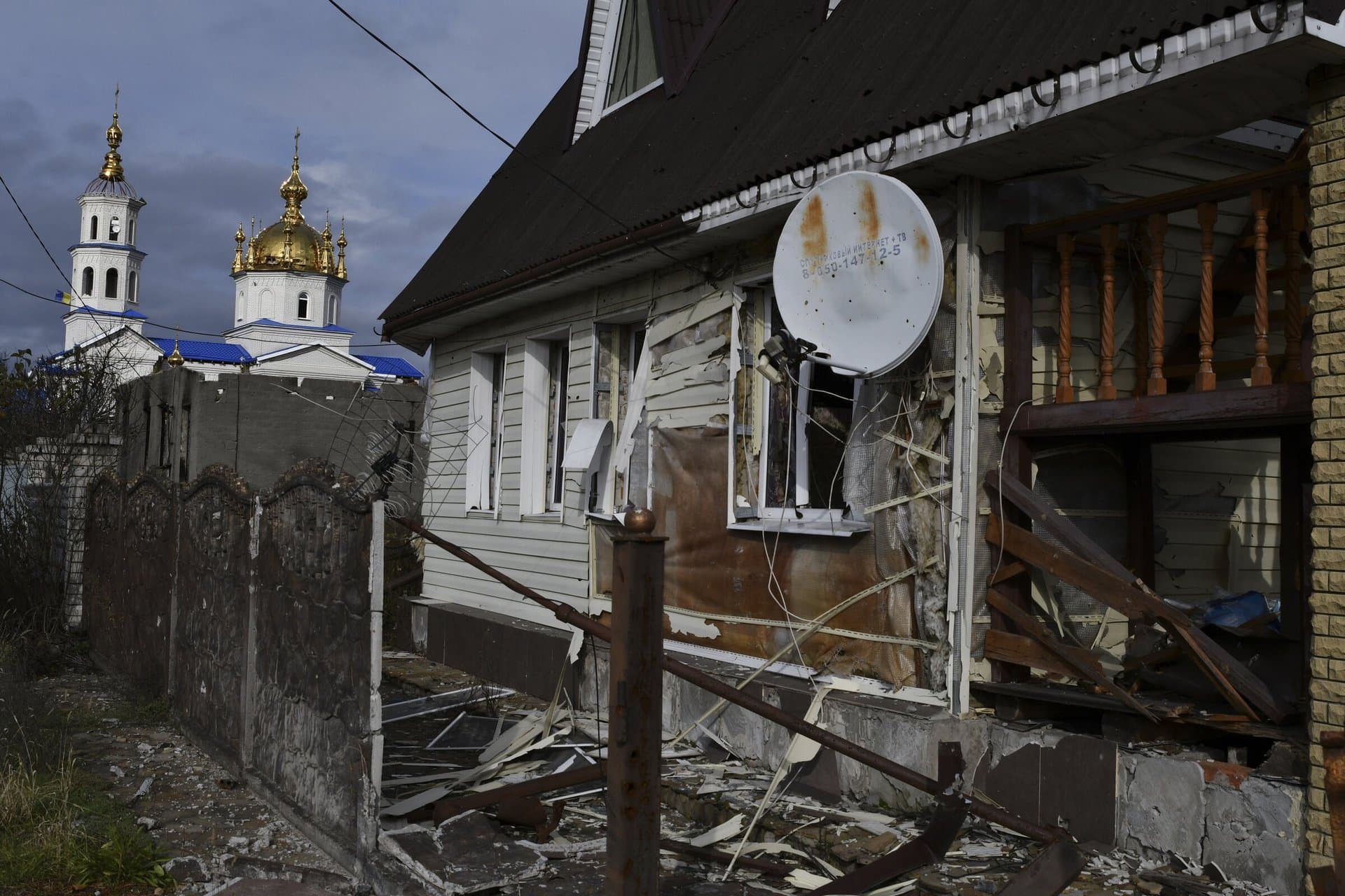 A view of buildings damaged by shelling with an Orthodox Church in village of Shchurove