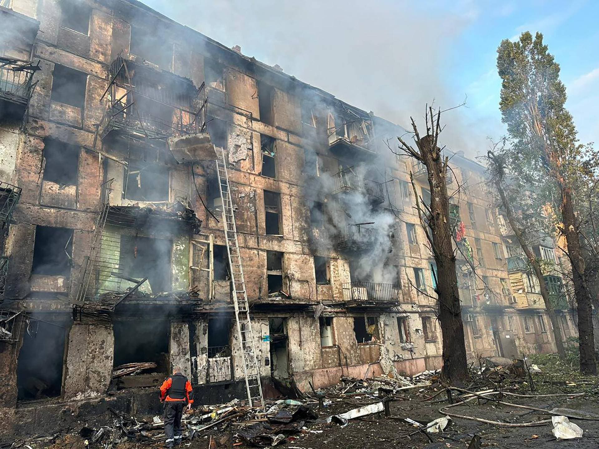 In this photo released by Dnipro Regional Administration, emergency workers extinguish a fire after missiles hit a multi-story apartment building in Kryvyi Rih, Ukraine, Tuesday, June 13, 2023.