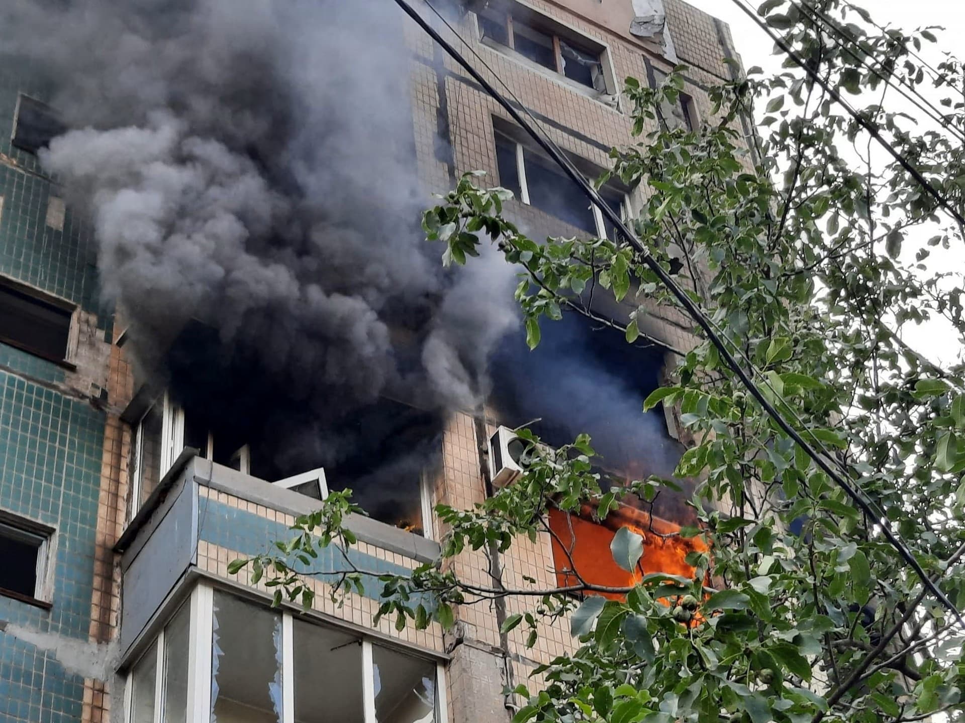An apartment building burns after it was hit by a Russian missile strike in Kryvyi Rih
