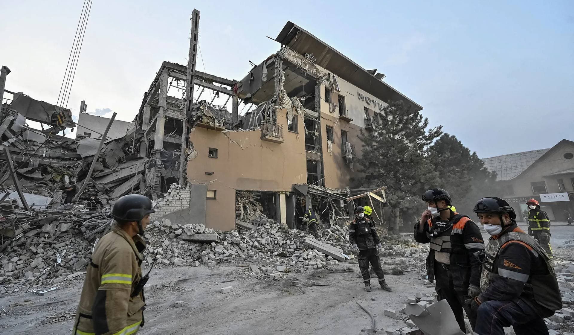 Rescuers stand at a site of a Russian missile strike in Kryvyi Rih